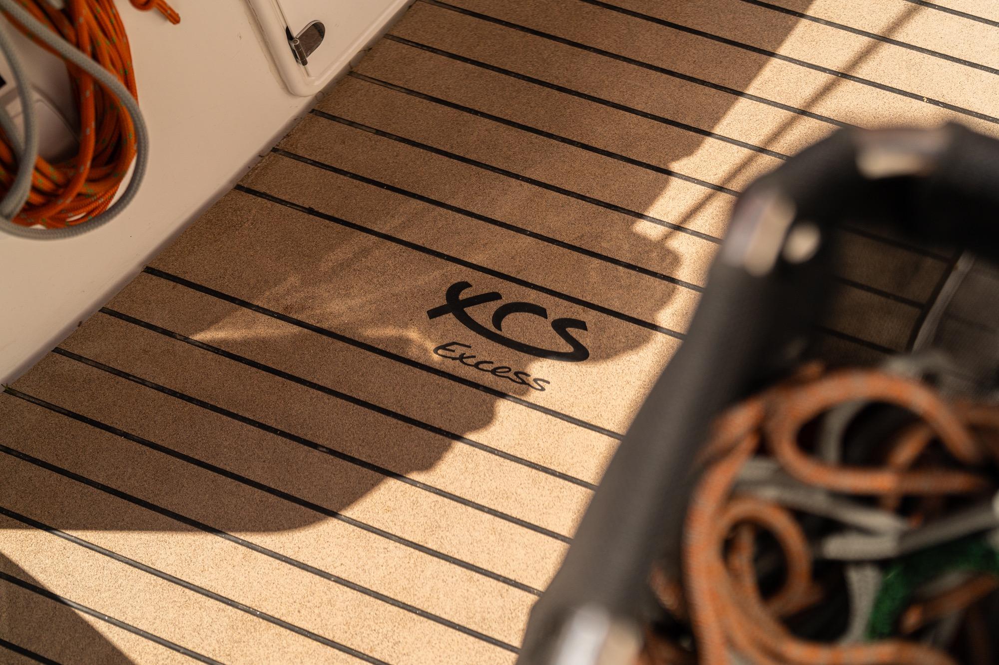Deck of 2026 Excess 13 yacht with logo and nautical equipment.