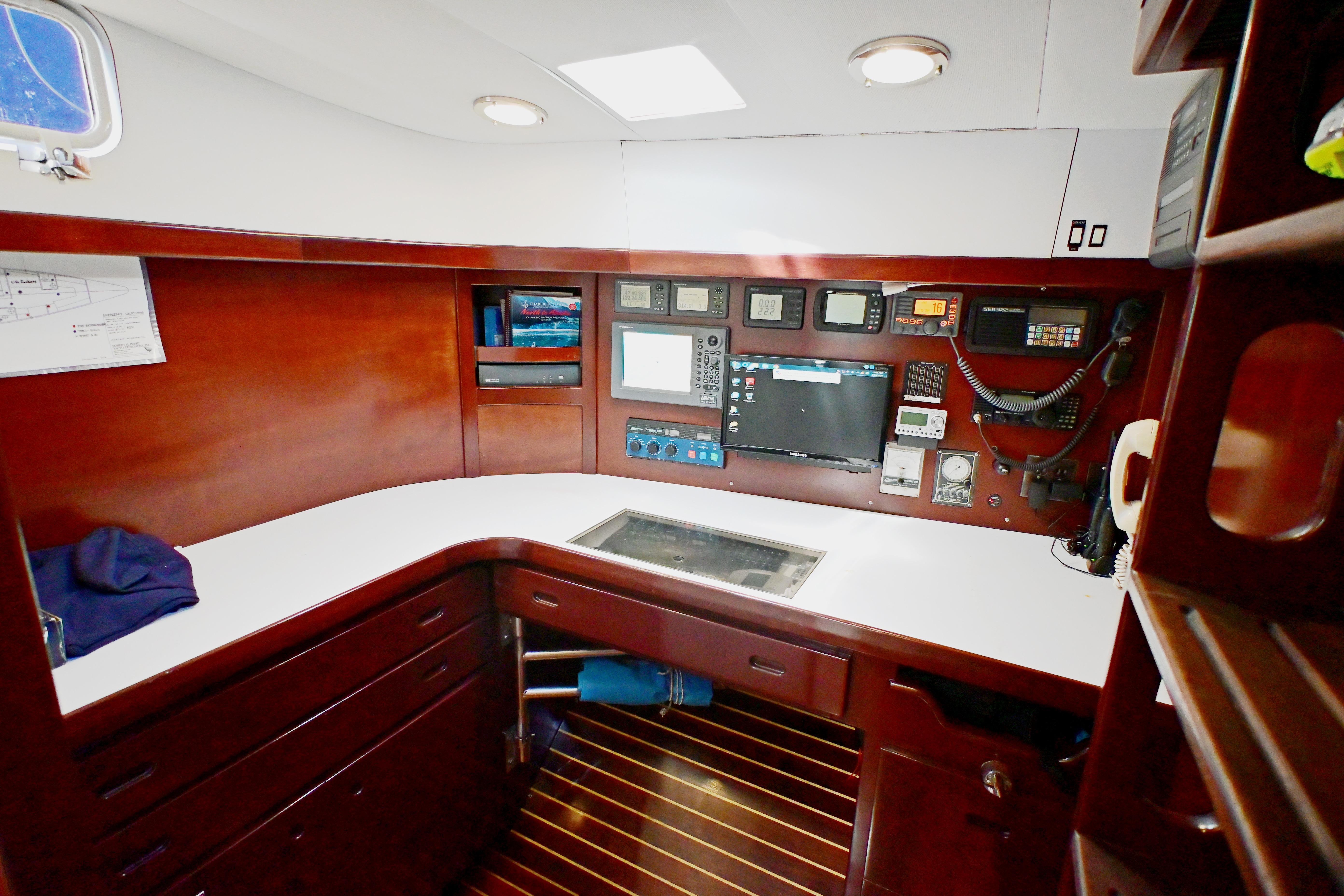Navigation station of a 1968 Abeking & Rasmussen Tripp 74 yacht, featuring control panels and equipment.