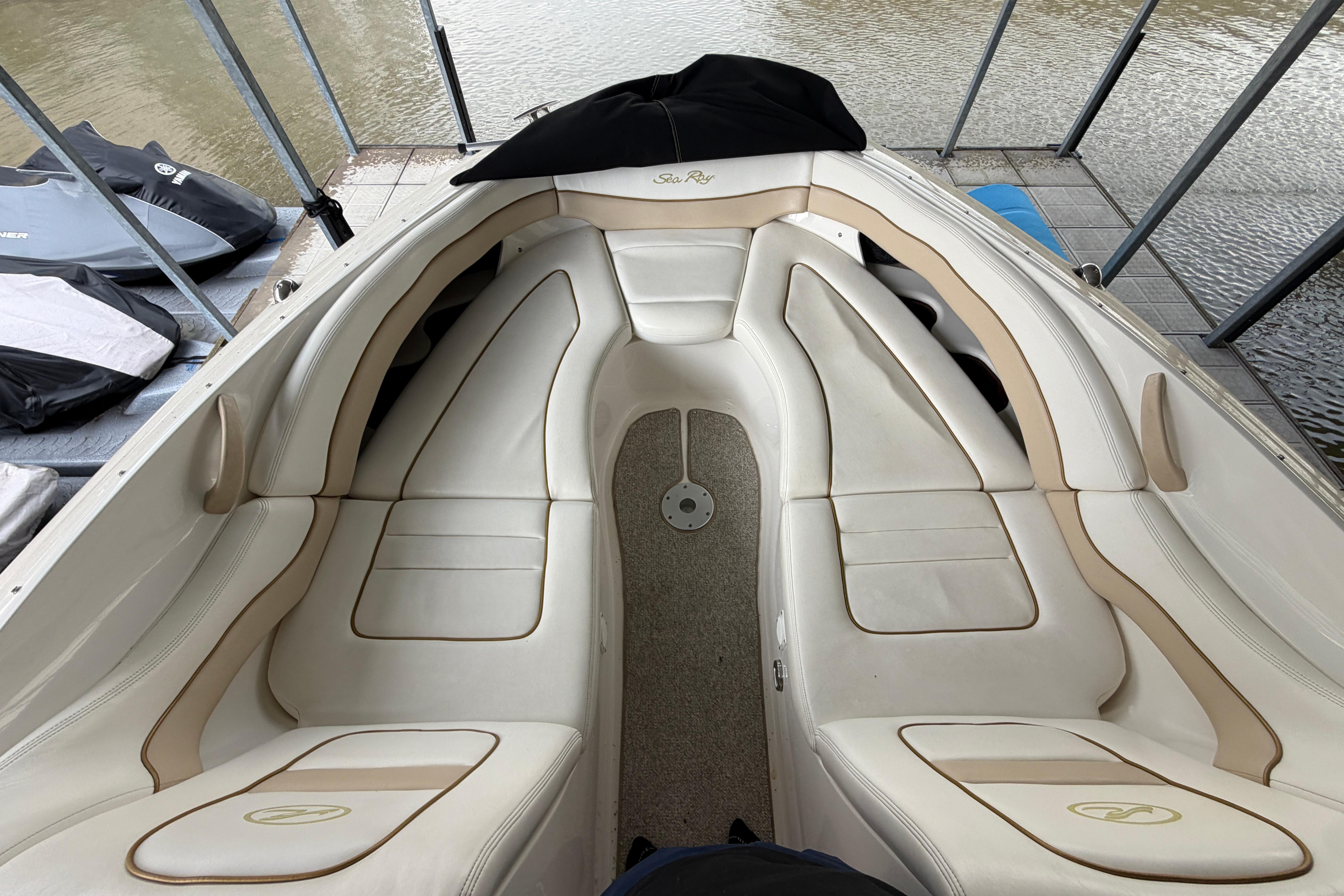 2003 Sea Ray 290 Bowrider interior with white leather seating and water view.