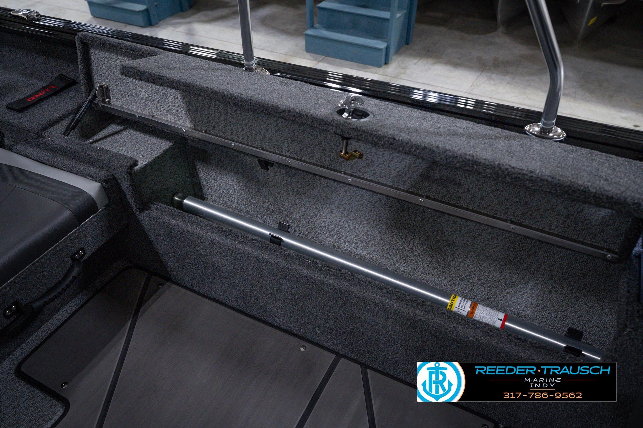 Interior view of 2026 Lund 1875 Impact XS SS boat, featuring storage and seating area.