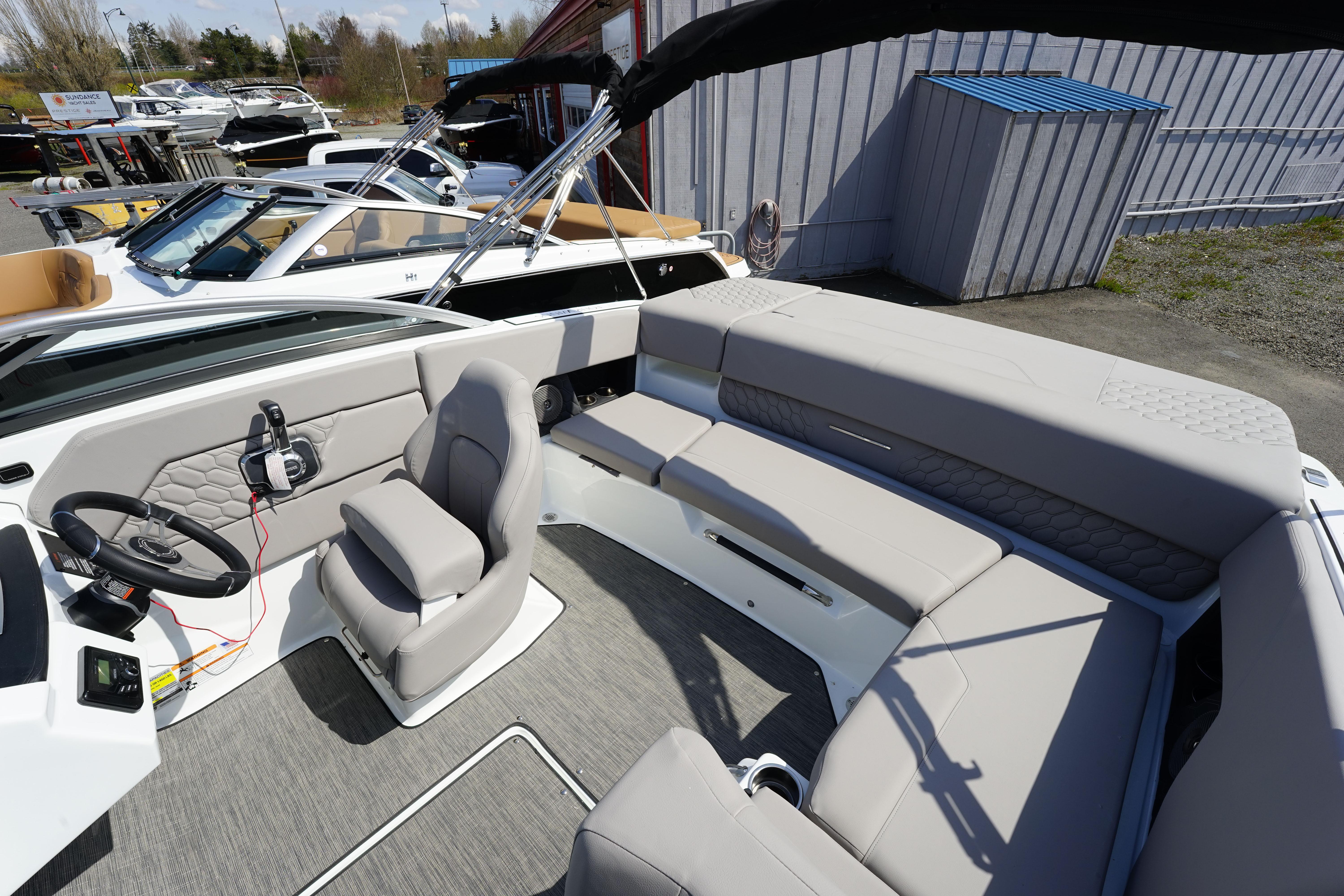 2023 Four Winns H1 boat interior with gray seating and steering console.