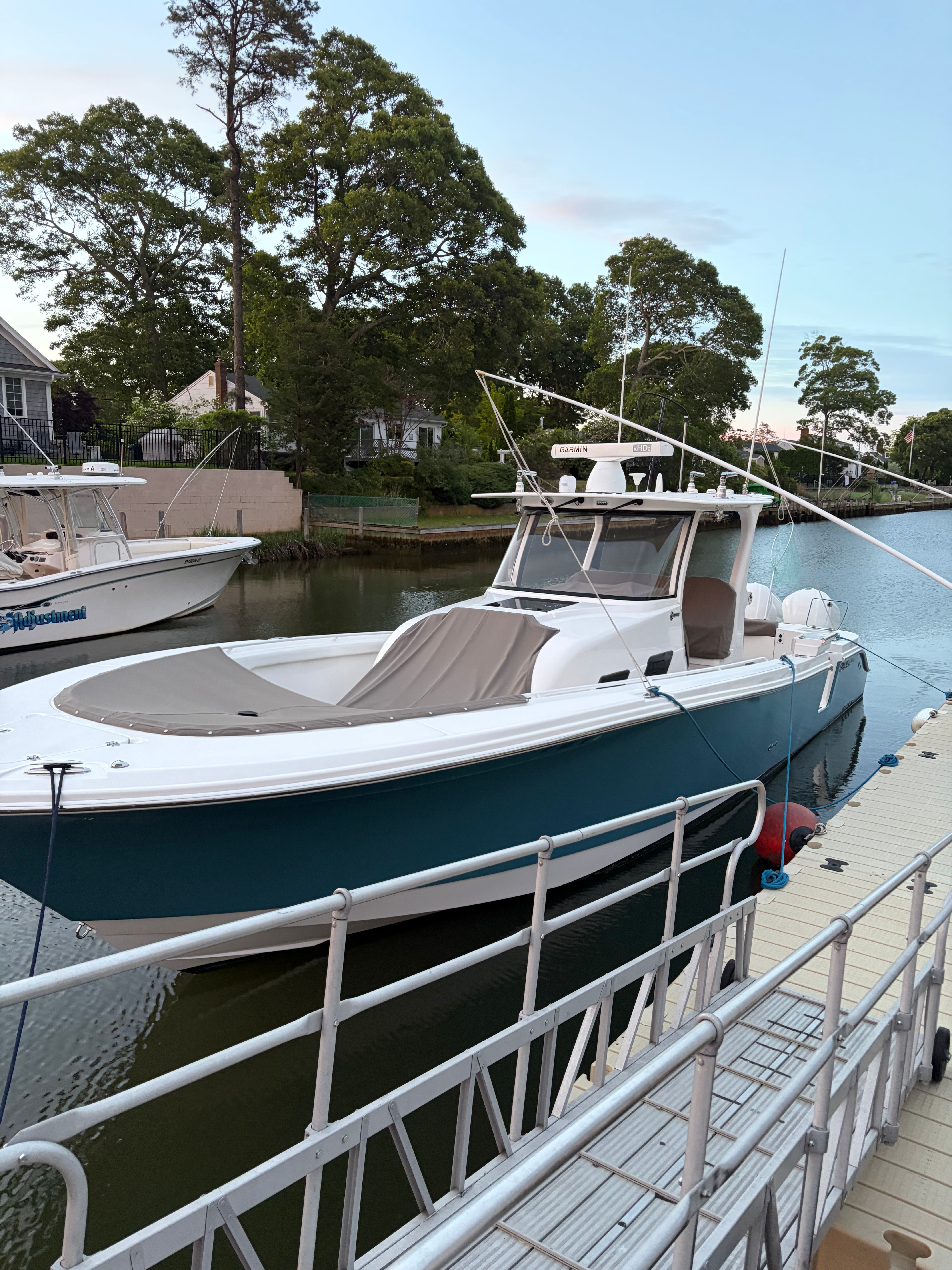 2019 Edgewater 370CC boat docked by the water.