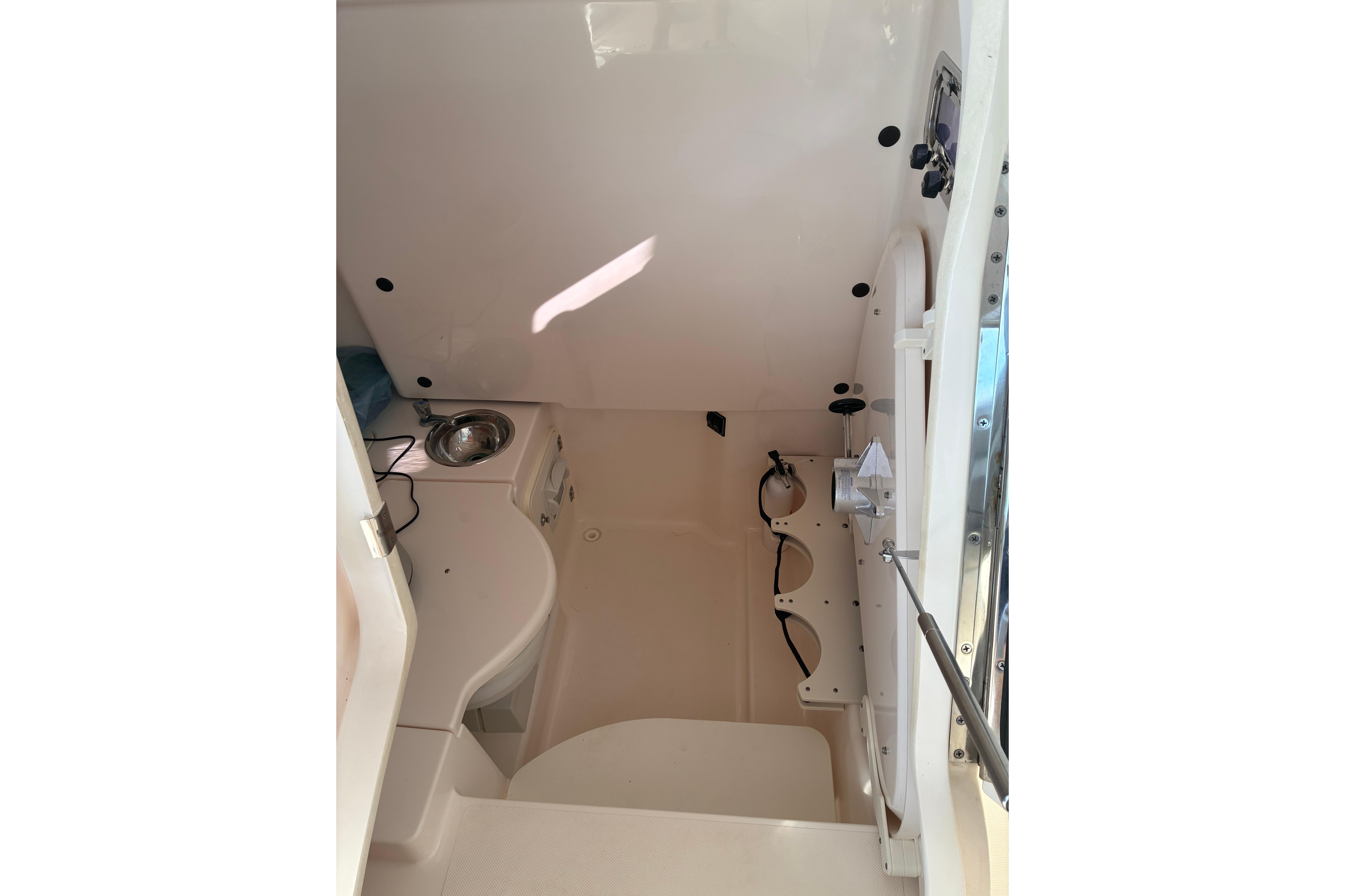 Interior of a 2015 Pursuit ST 310 Sport boat, featuring a compact cabin space.