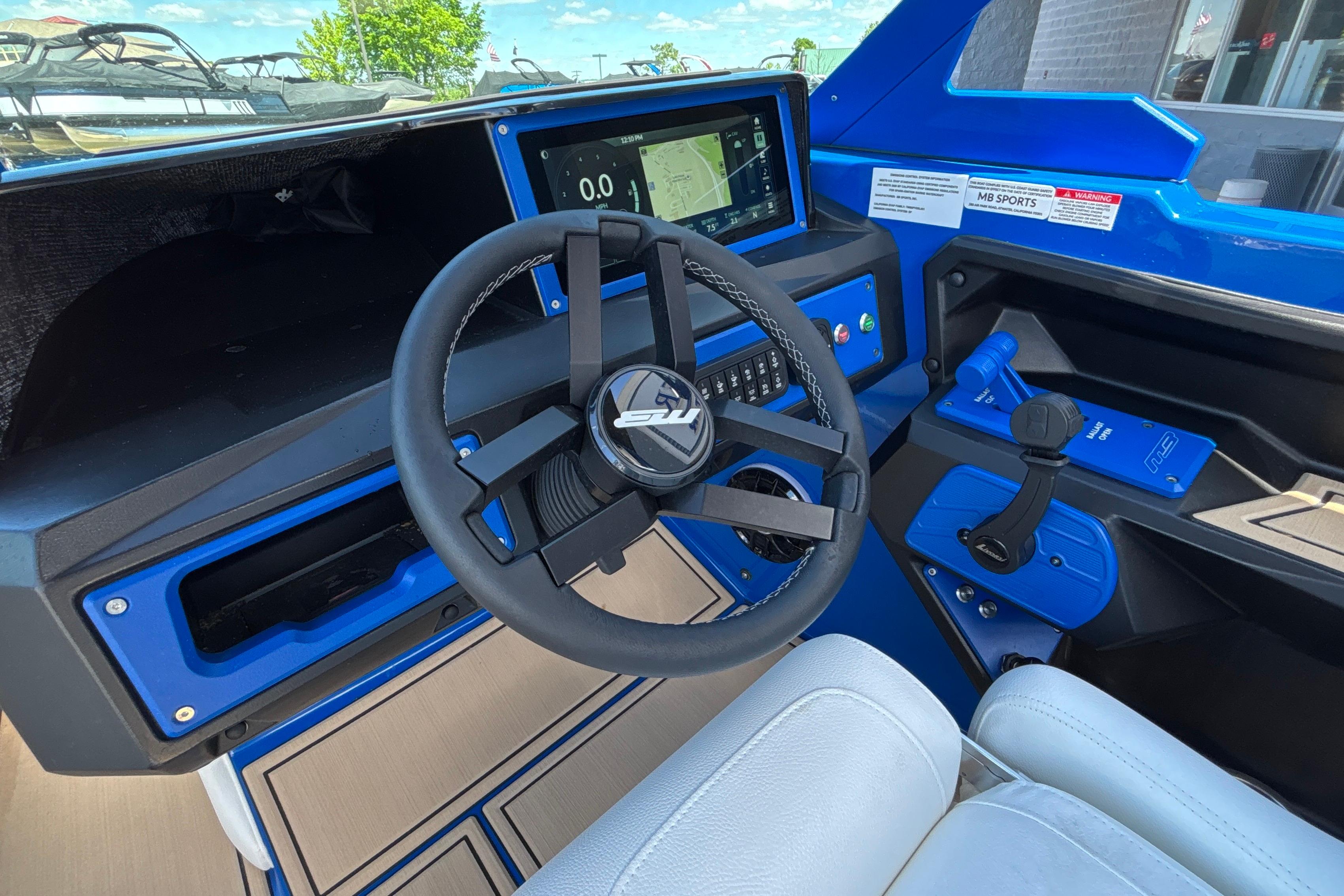 Interior of 2026 MB B52 23 Alpha boat with modern steering and dashboard controls.