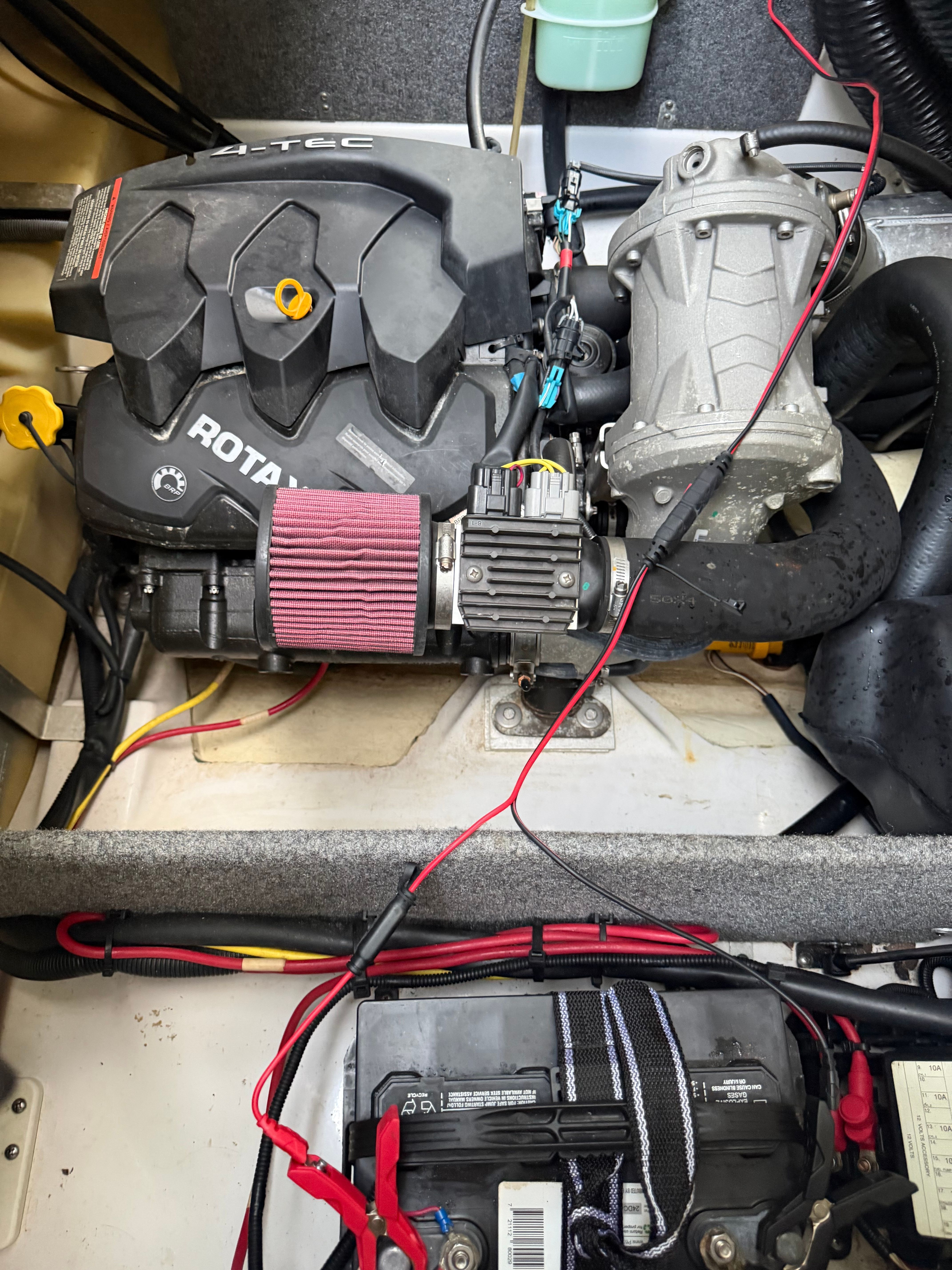 Engine compartment of a 2015 Scarab 165 boat with visible engine and battery.