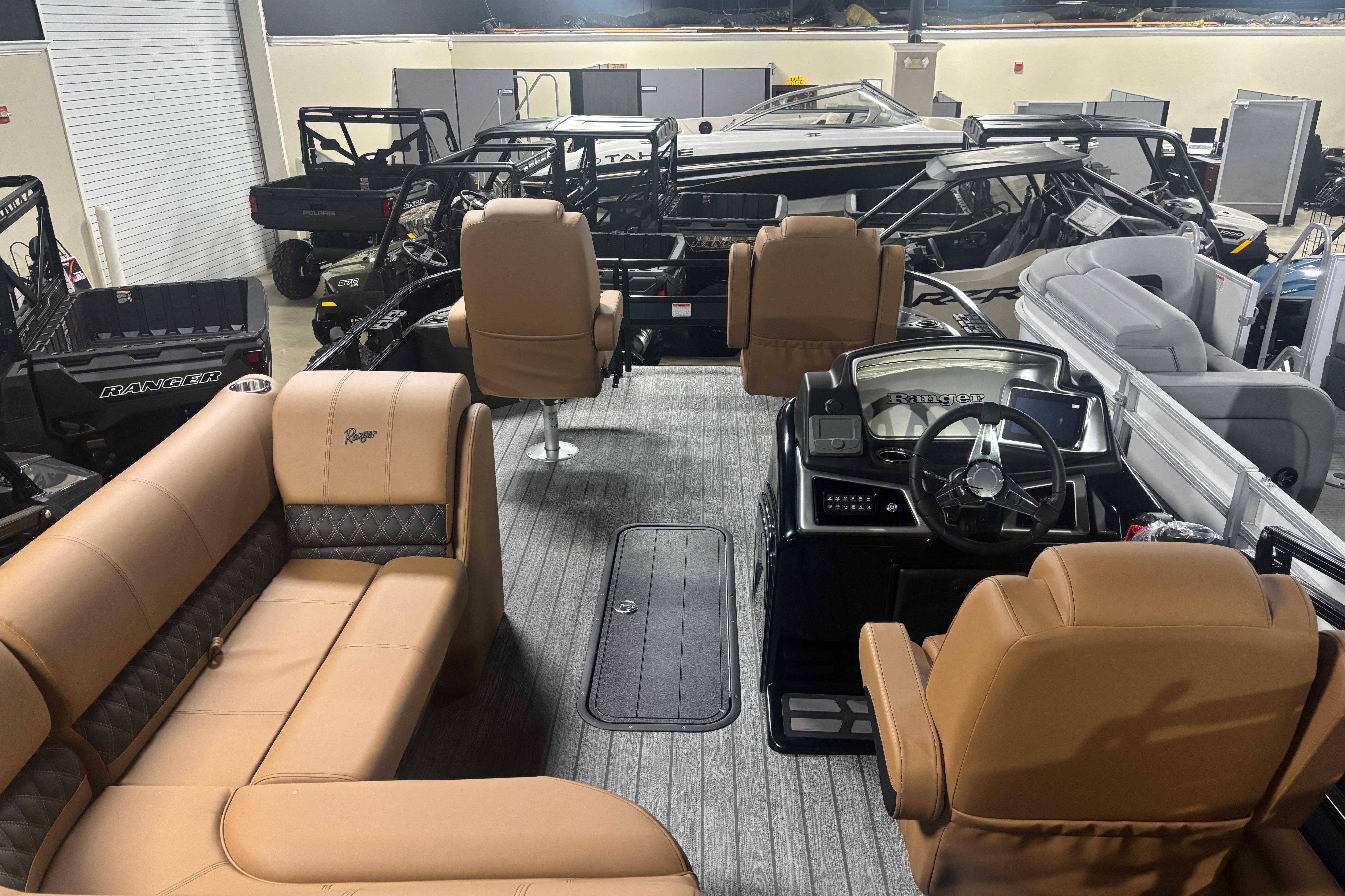 Interior view of a 2026 Ranger 223F boat with tan seating and modern dashboard.