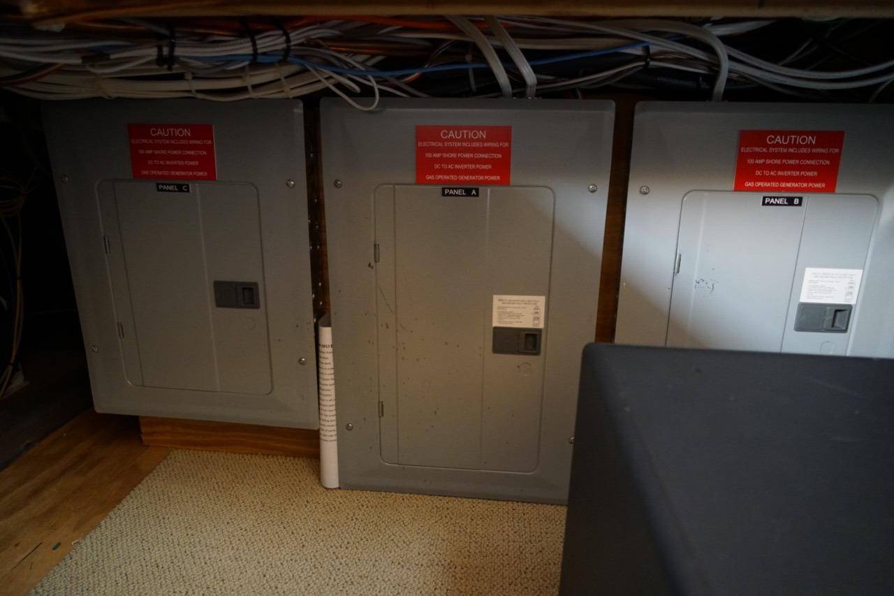 Electrical panels on a 2000 Stardust Cruisers 83'x17' houseboat, labeled with caution signs.