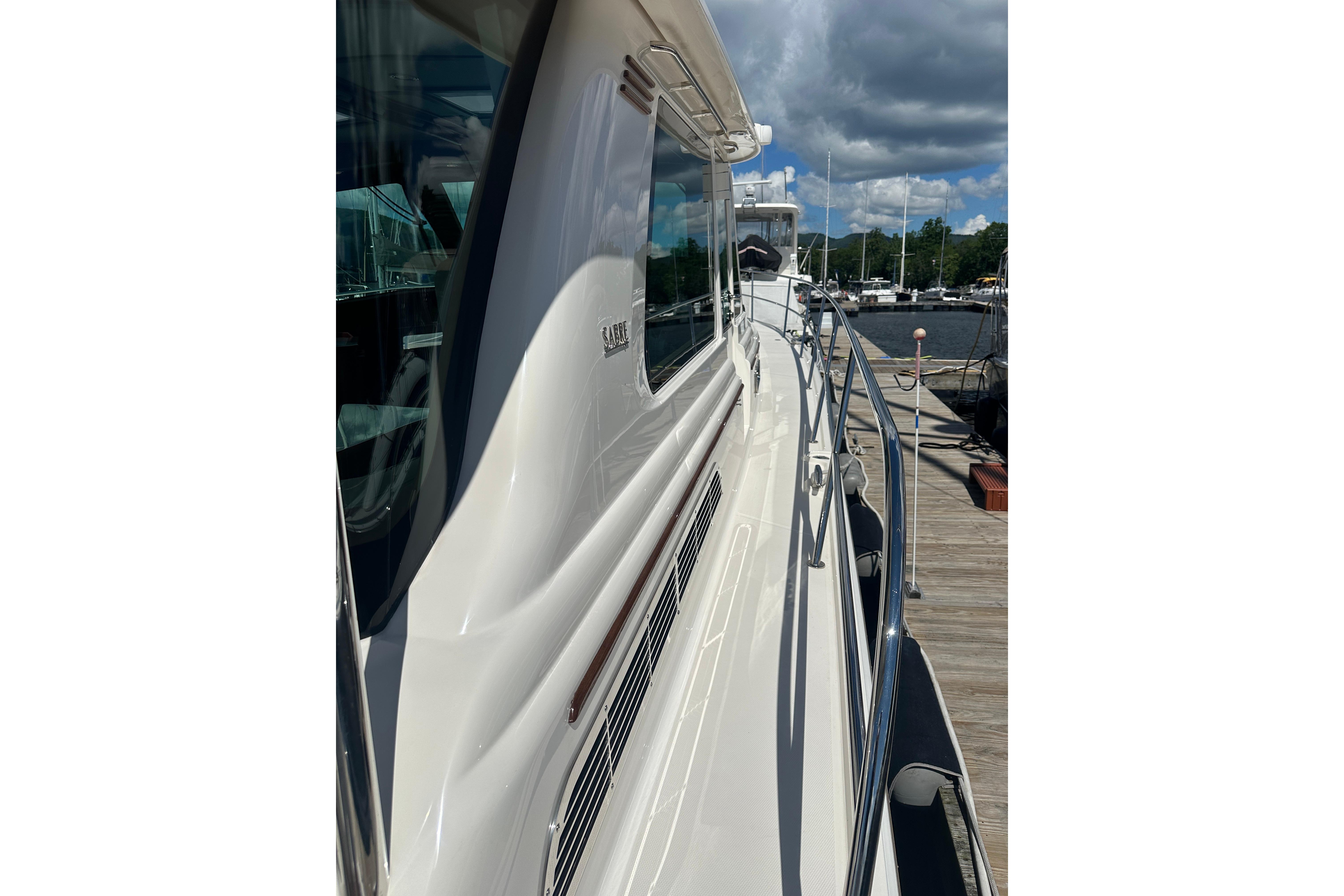 2025 Sabre 48 Salon Express yacht docked, showcasing sleek design and polished exterior.