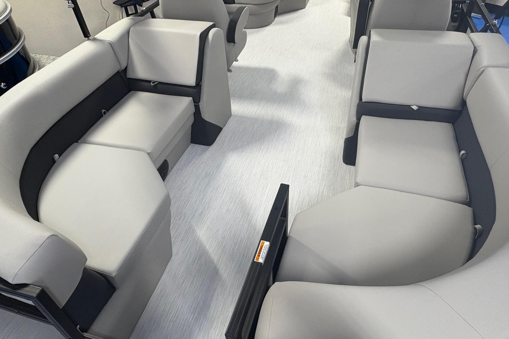 Luxurious seating inside 2026 Dockside 22DQ boat, featuring modern gray upholstery.