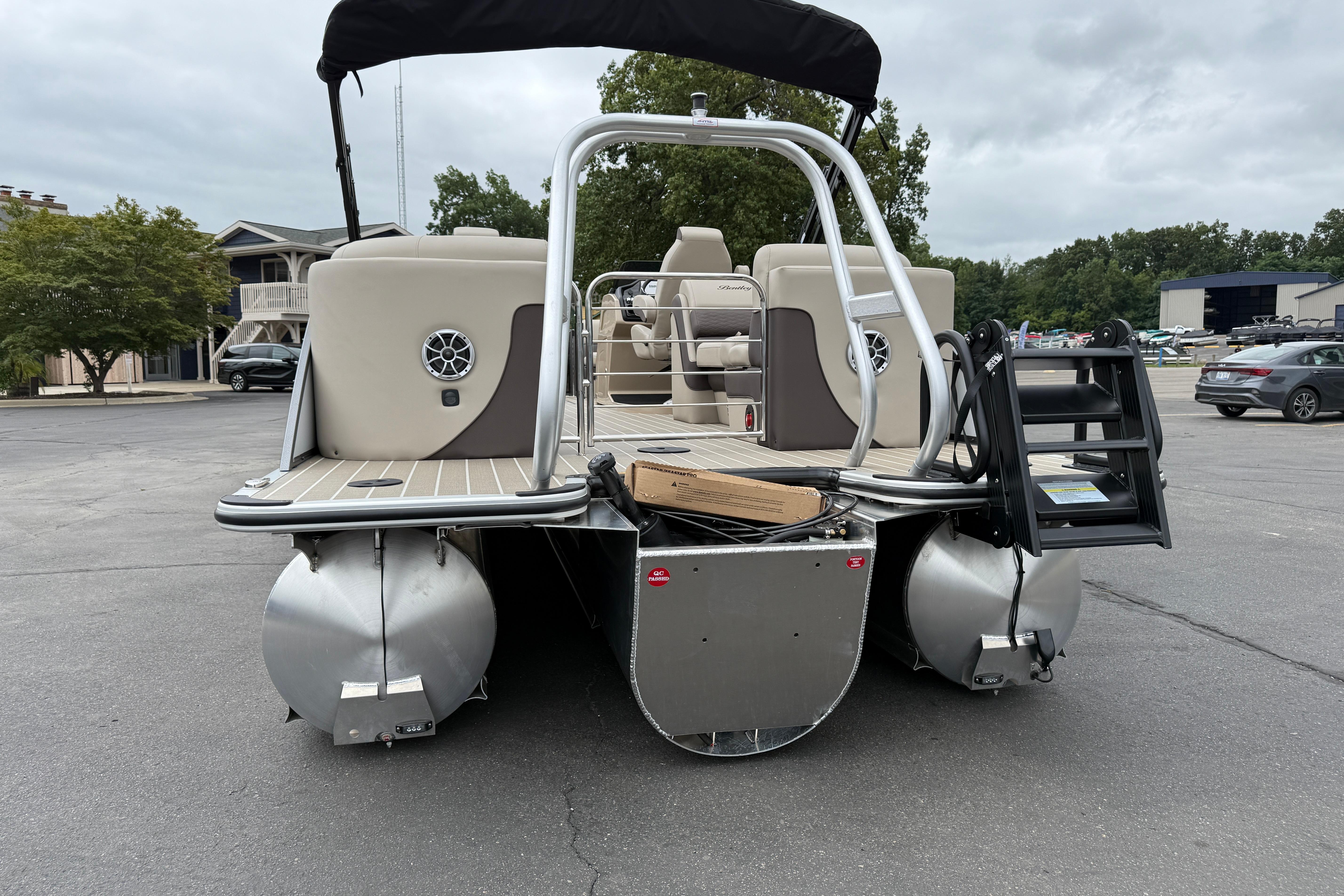 2026 Bentley Pontoons Elite 253 Admiral, rear view, parked on asphalt.