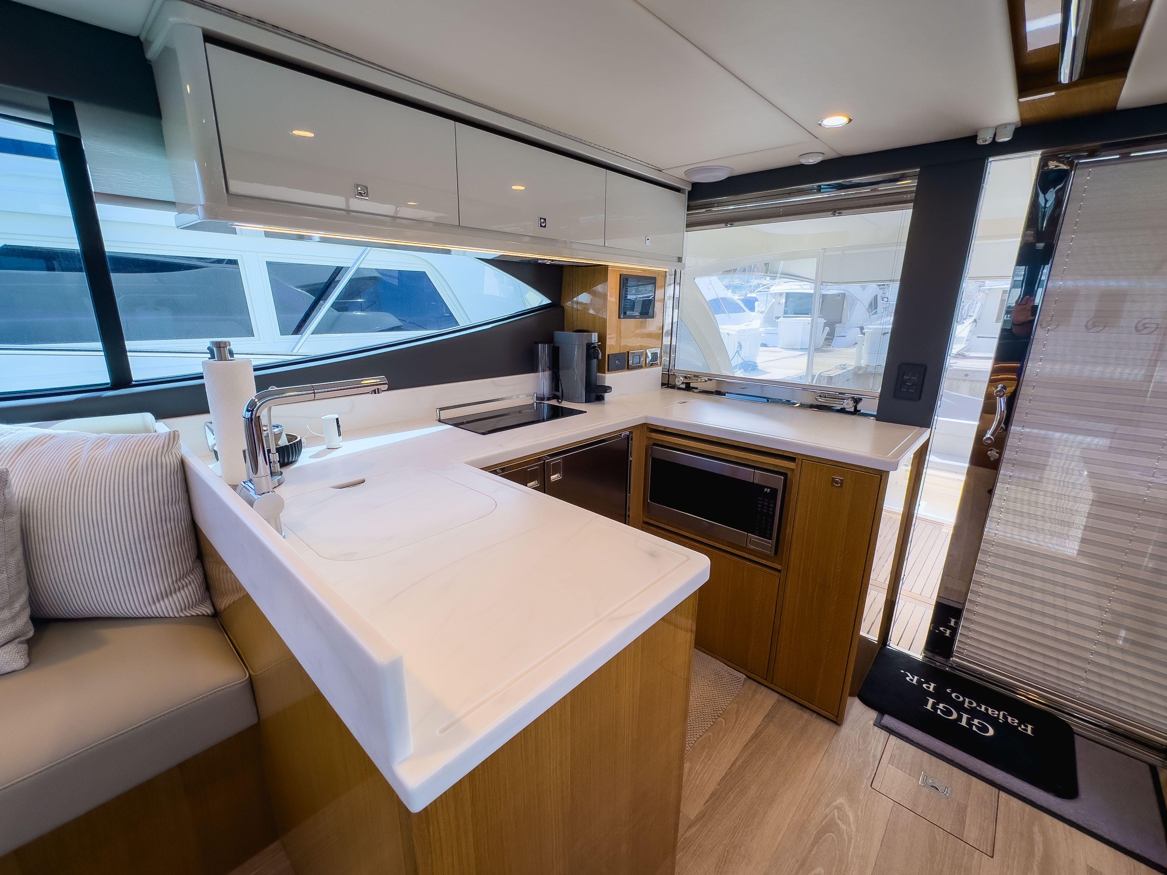 Modern kitchen interior of 2024 Riviera SMY 46 yacht with sleek countertops and appliances.