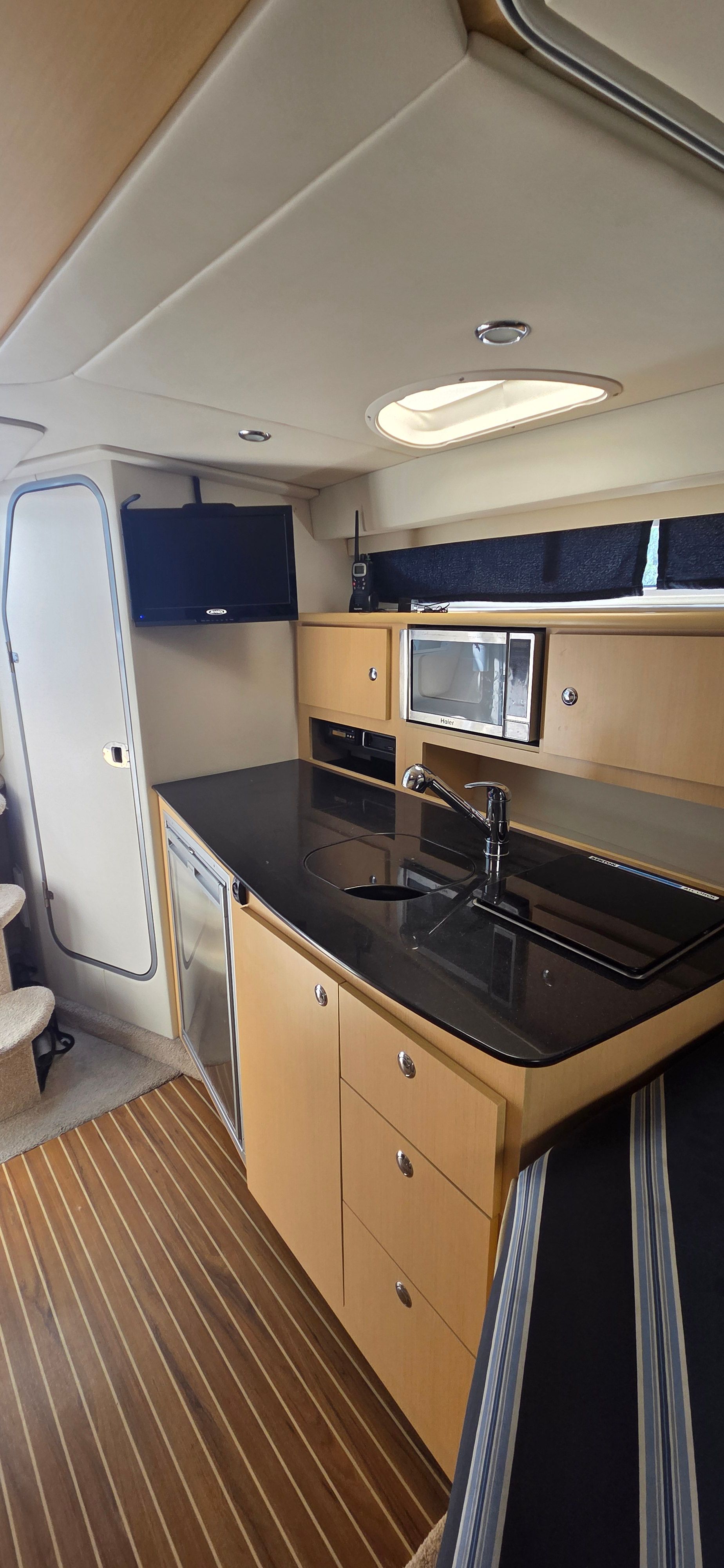 Interior of 2012 Bayliner 335 Cruiser featuring modern kitchen.