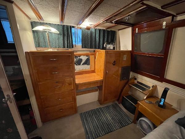 1951 Chris-Craft Catalina cabin interior with wooden furniture and cozy decor.
