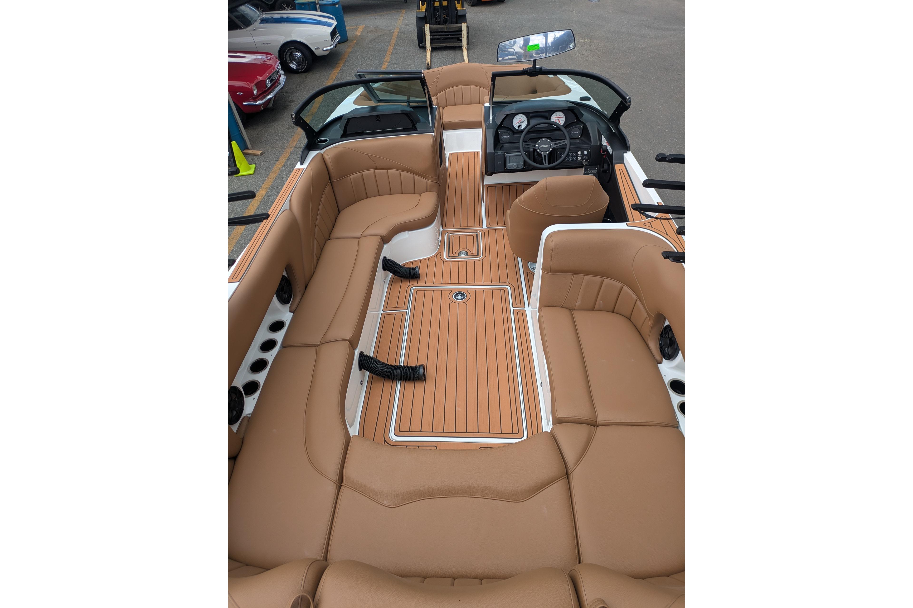 2026 MB B52-23 Classic LIMITED boat interior with tan leather seating and sleek dashboard.