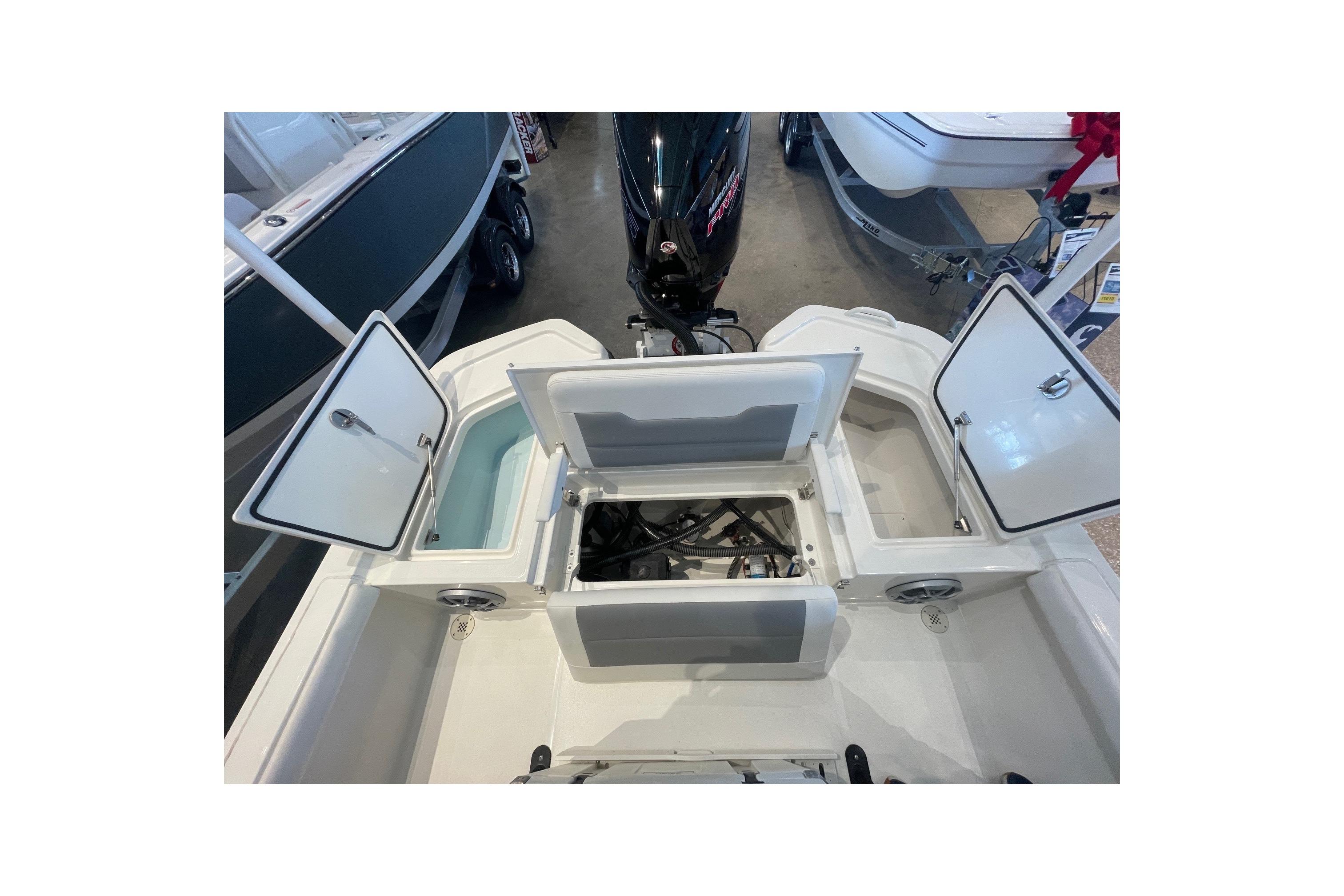 2026 Mako 24 APEX boat interior with open storage compartments and visible engine.