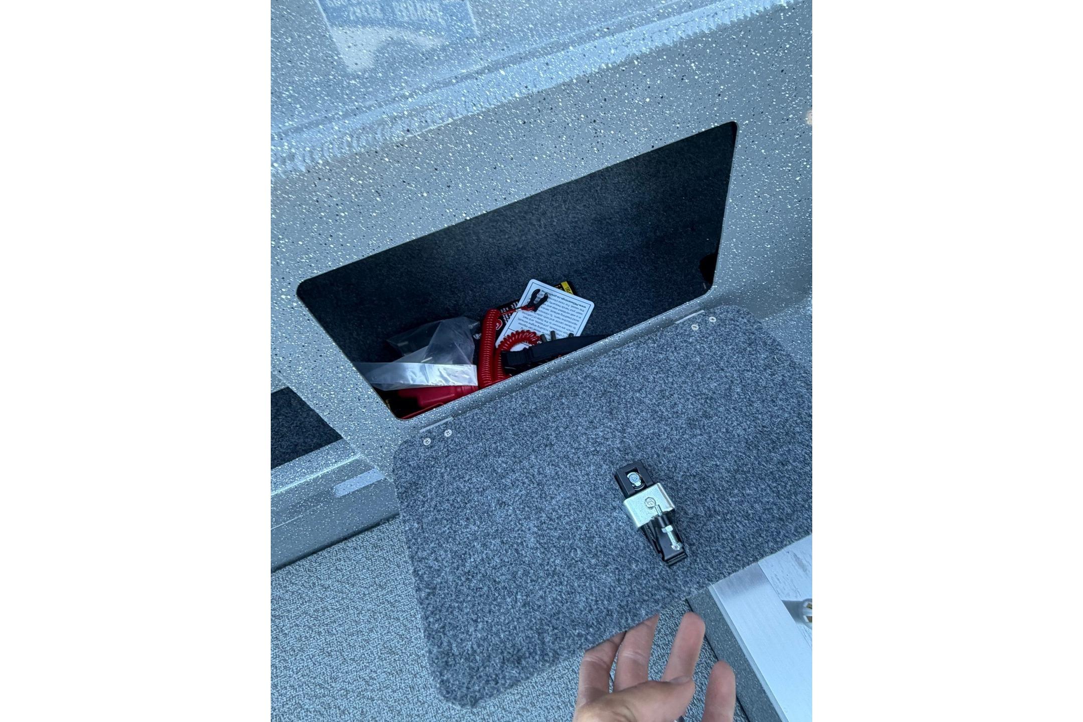Storage compartment in 2026 Thunder Jet 209 Rush OT boat, featuring secure latch and interior items.