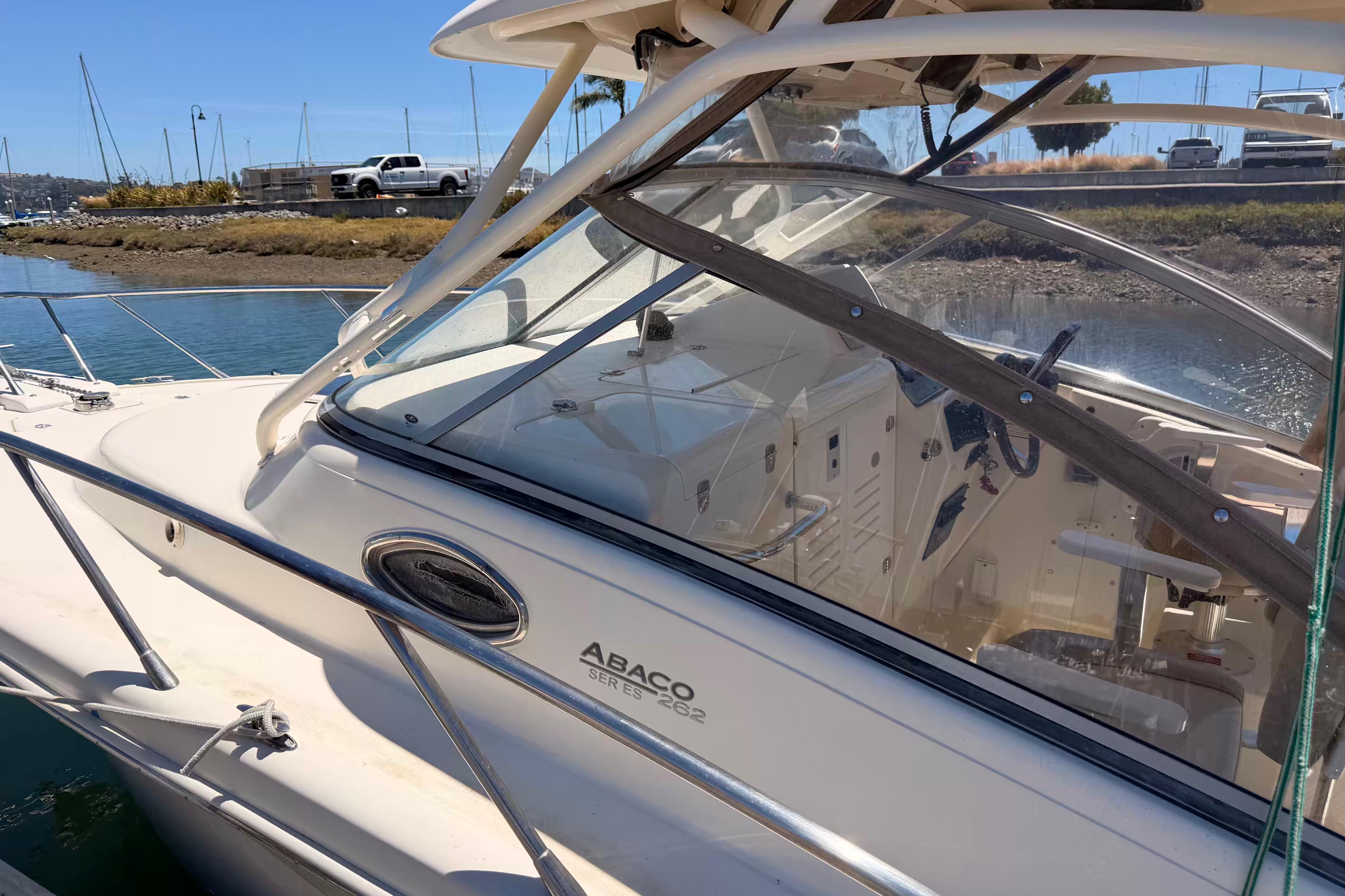 2007 Scout 262 Abaco boat docked near shoreline, showcasing sleek design and cockpit details.
