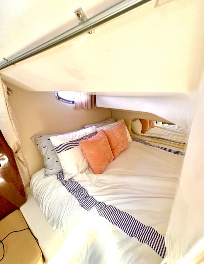 Cabin of the 2014 Regal 30 Express with a cozy bed and pillows.