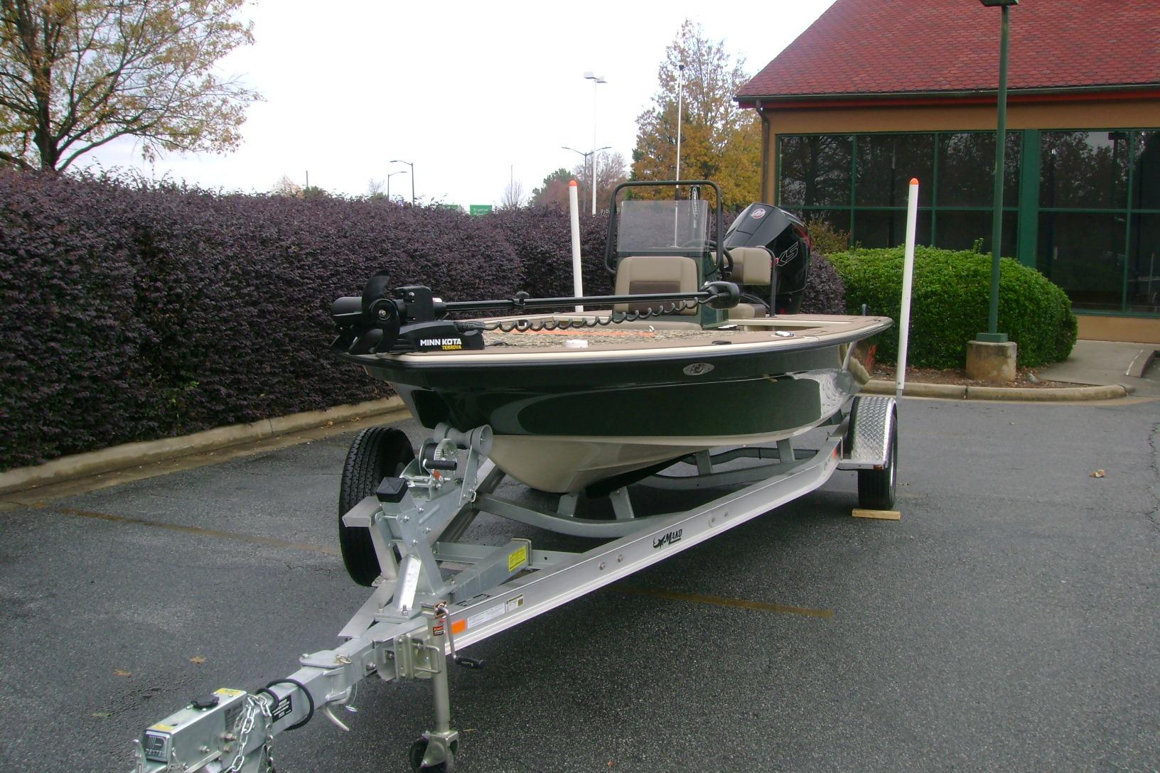 2025 Mako 18 Pro Skiff Backwater Edition on trailer, parked outdoors.