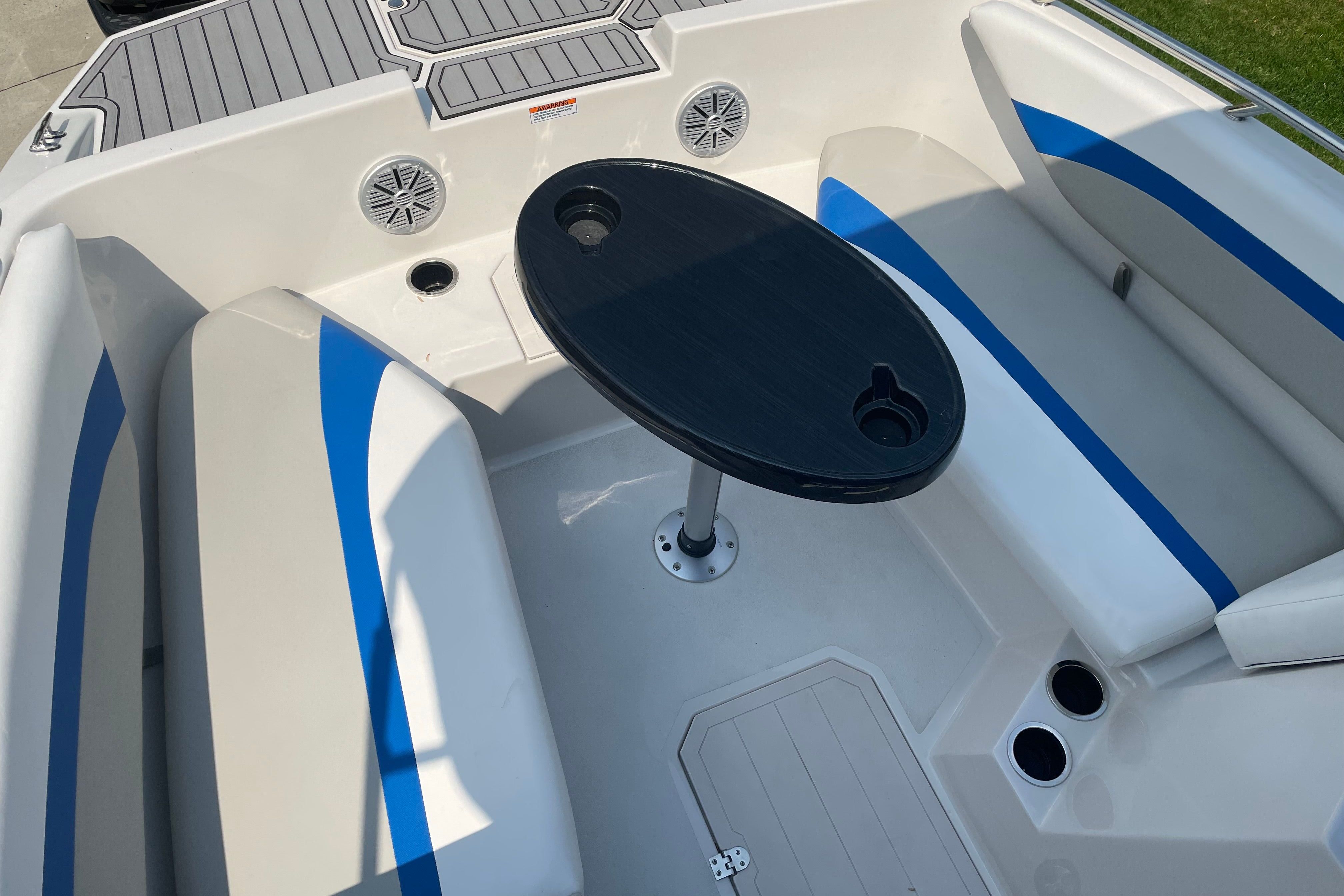 The image shows the interior of a Starcraft SVX 171 OB boat with seating and a table.