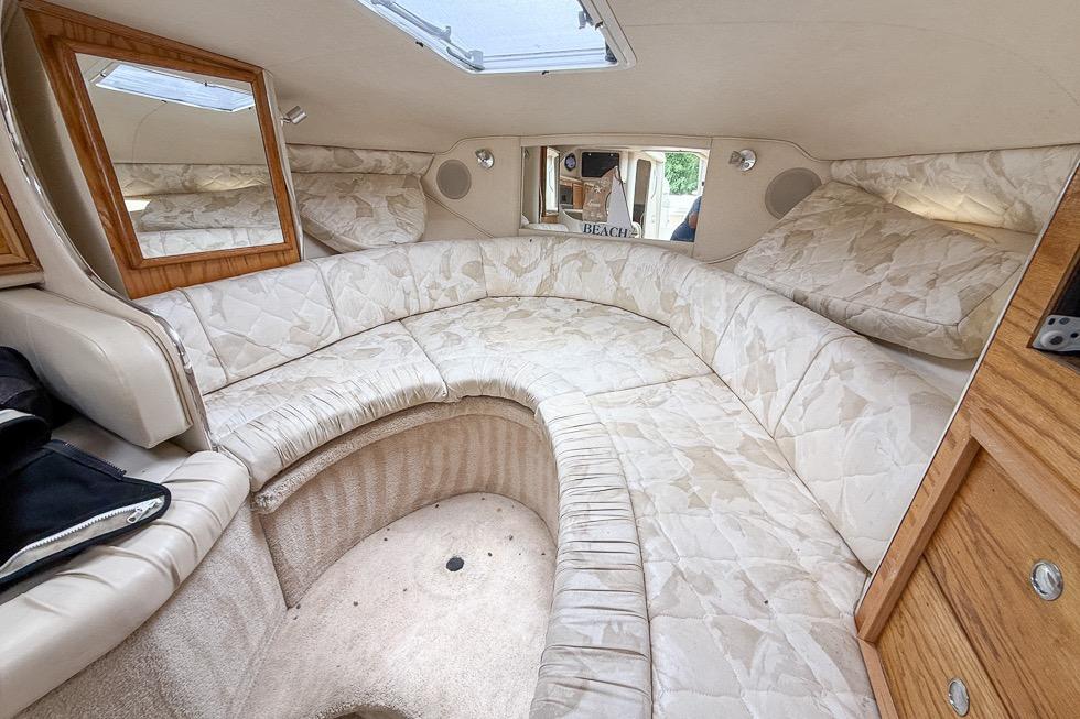Interior of 1999 Sea Ray 290 Sundancer boat with cozy seating and elegant decor.