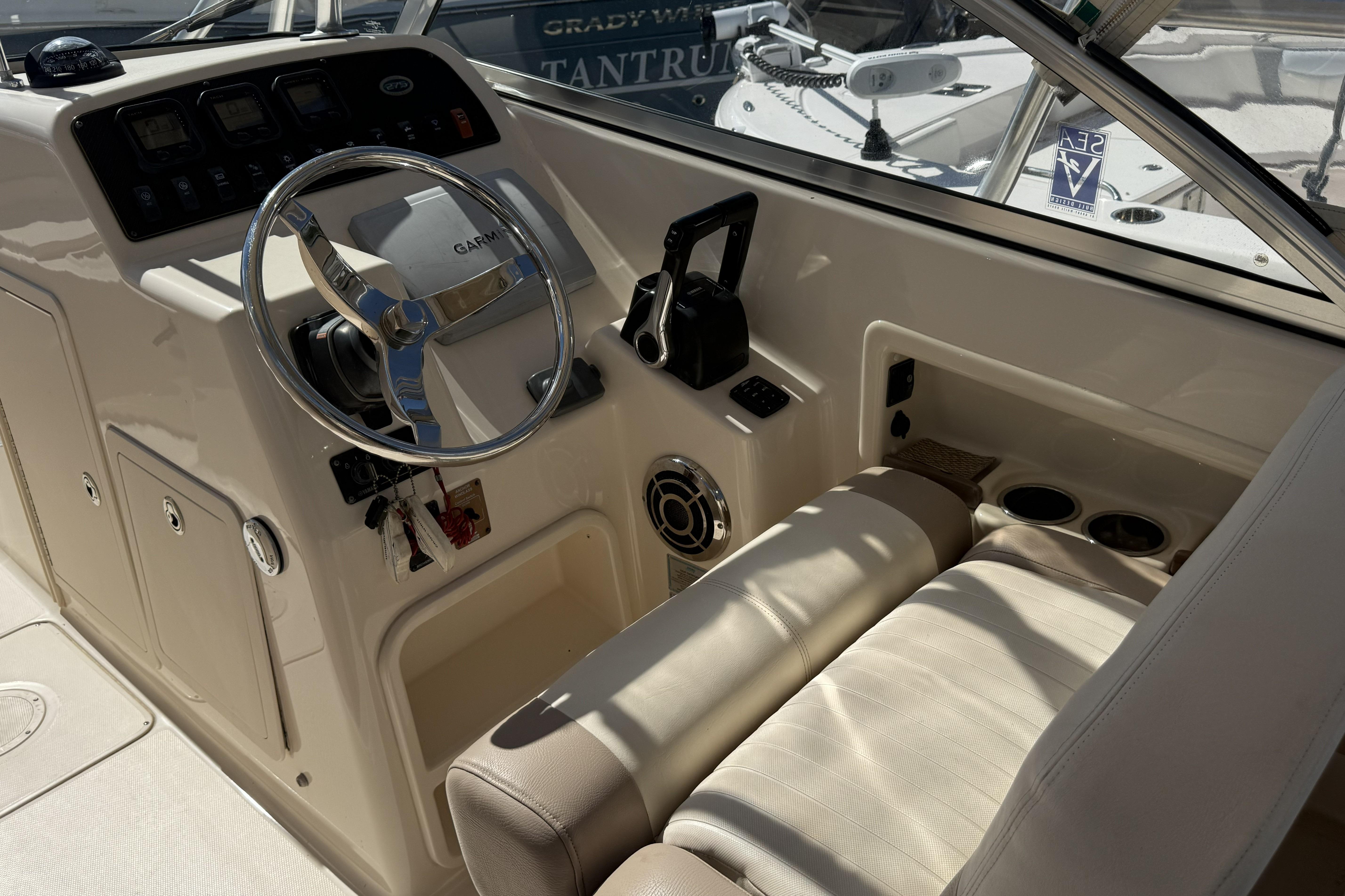 2014 Grady-White Freedom 275 boat cockpit with steering wheel and controls.