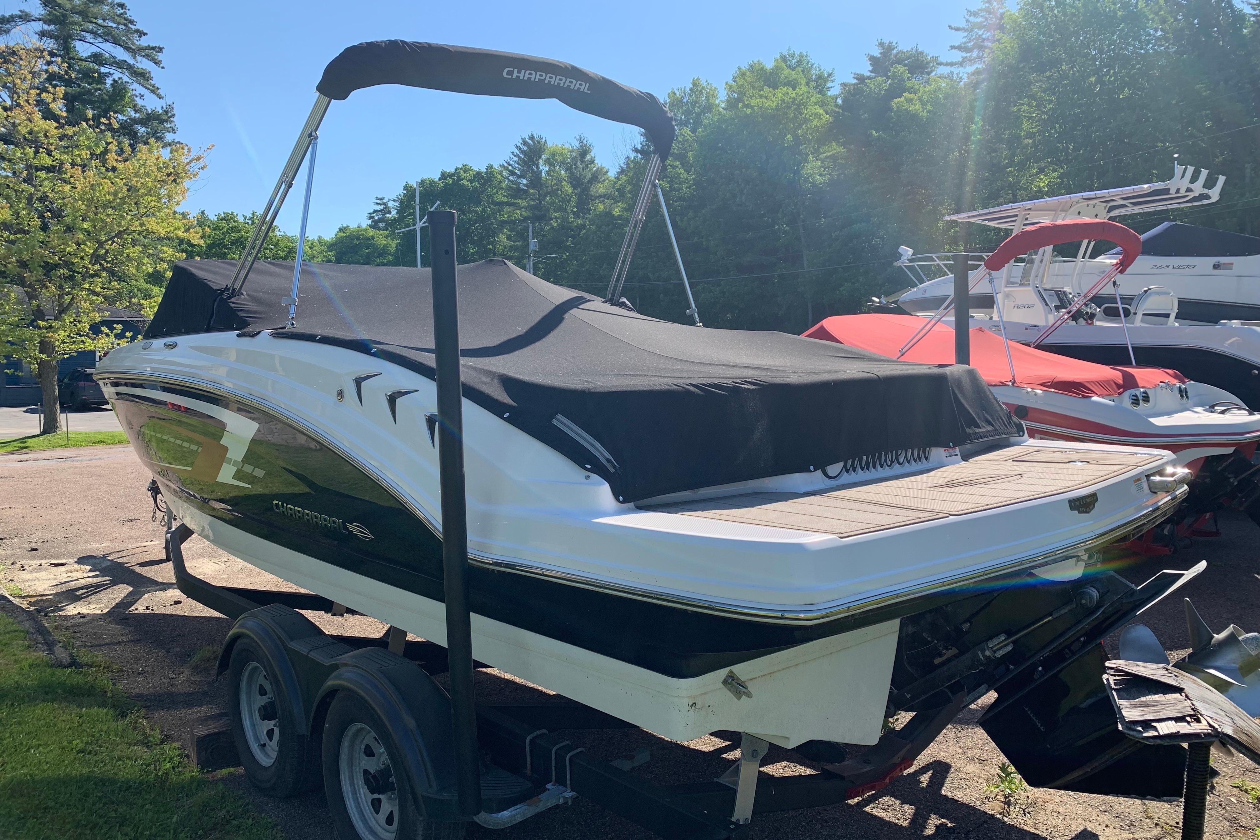 2022 Chaparral 23 SSi boat on trailer, covered, in outdoor setting.