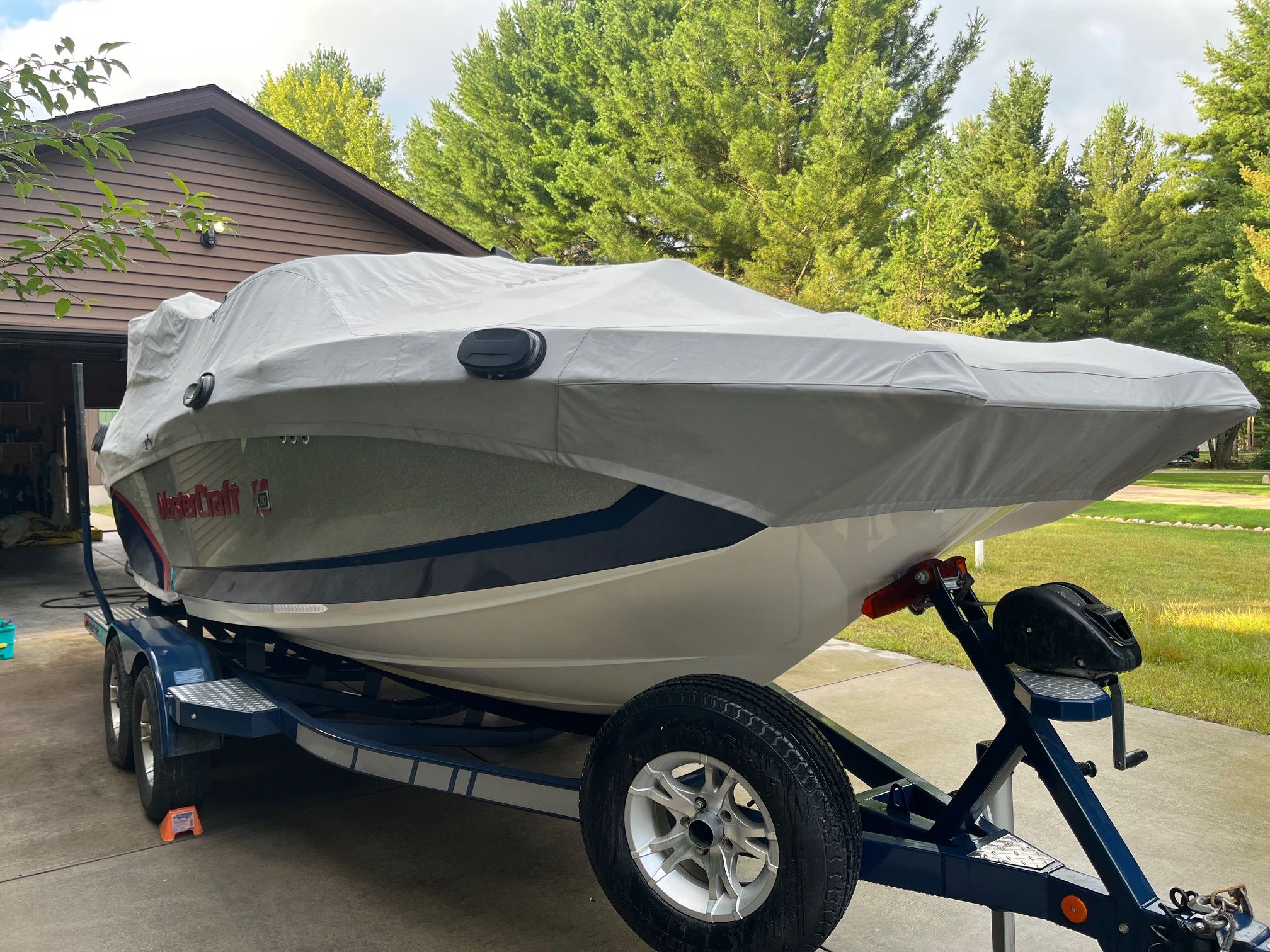 2015 MasterCraft X20 boat with cover on trailer.