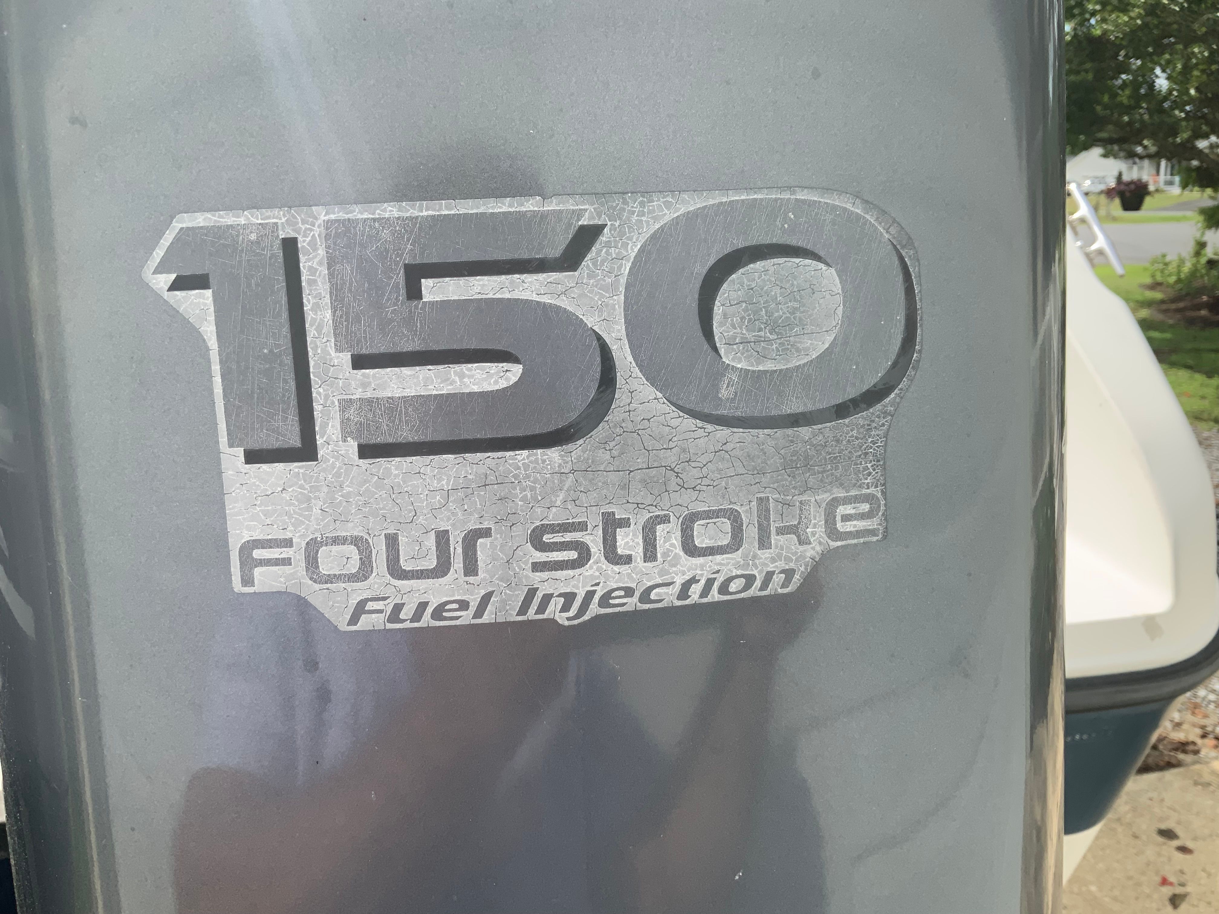 Close-up of a 150 HP outboard motor labeled "Four Stroke Fuel Injection."