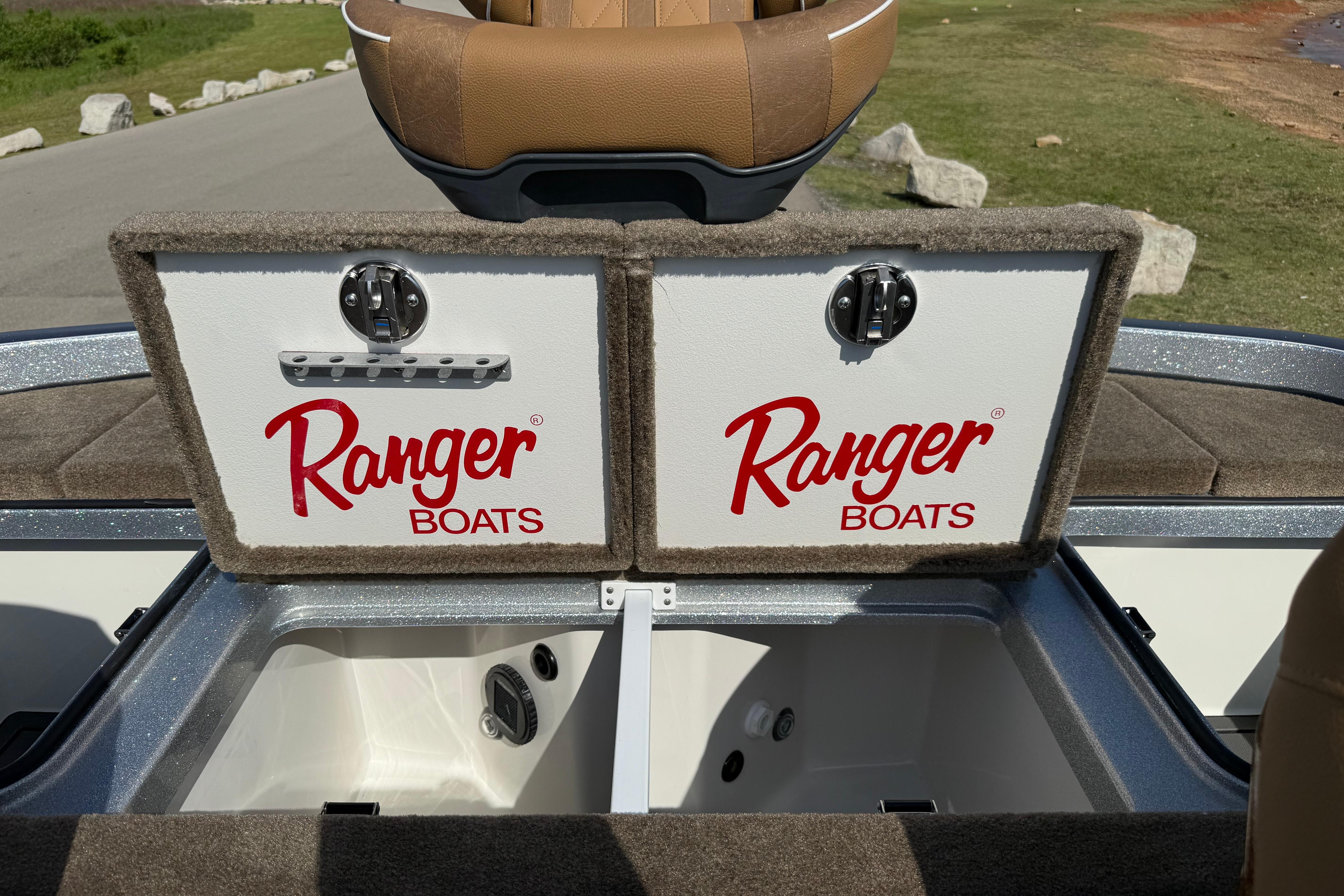 2026 Ranger Z521R boat storage compartments with Ranger Boats logo, open on a sunny day.