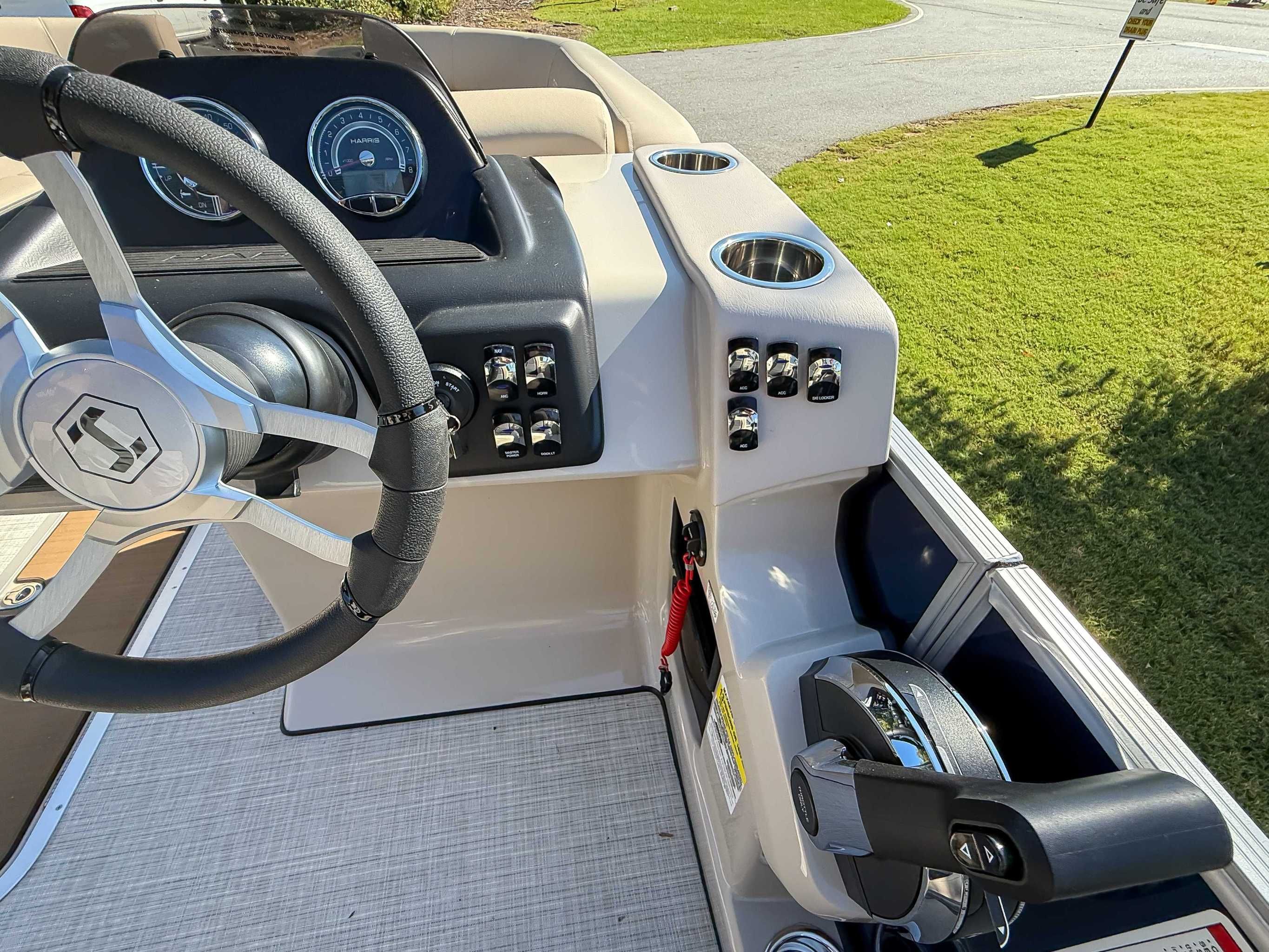2025 Harris Cruiser 250 CWDH helm with steering wheel and controls.