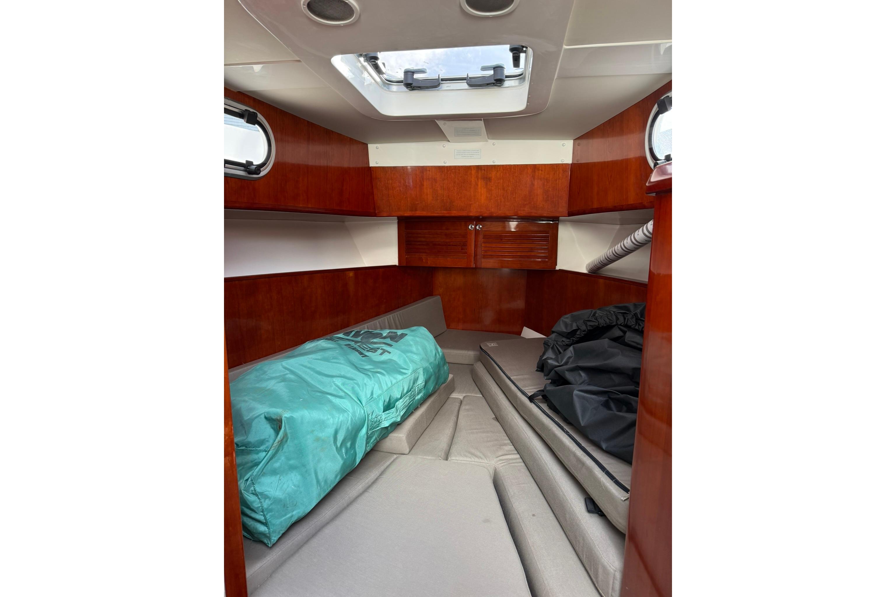 Cozy cabin interior of 2020 SeaPiper 35 boat with wooden finish and skylight.