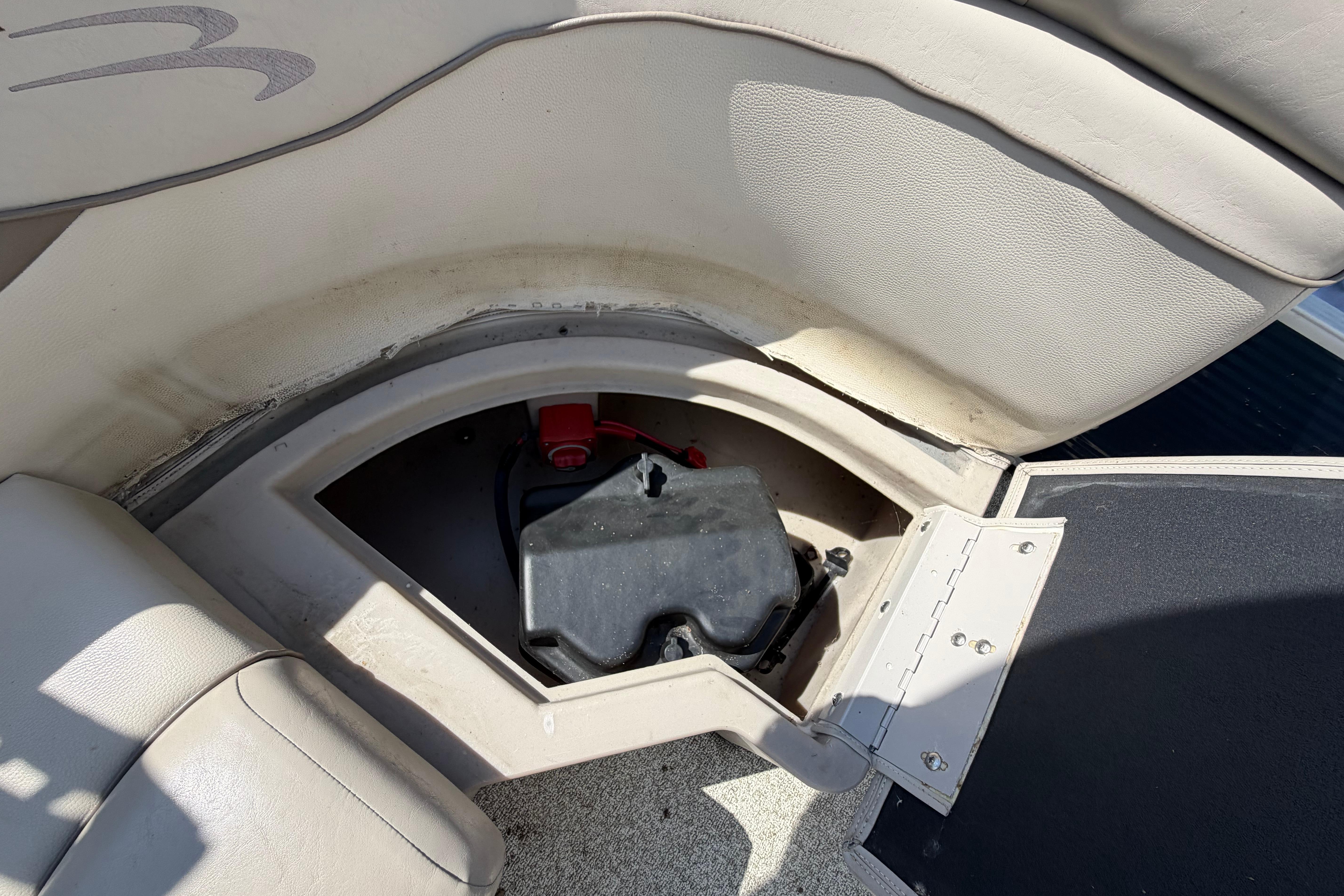 Storage compartment in a 2017 Bennington 25 SSXAPG boat, featuring a battery box.