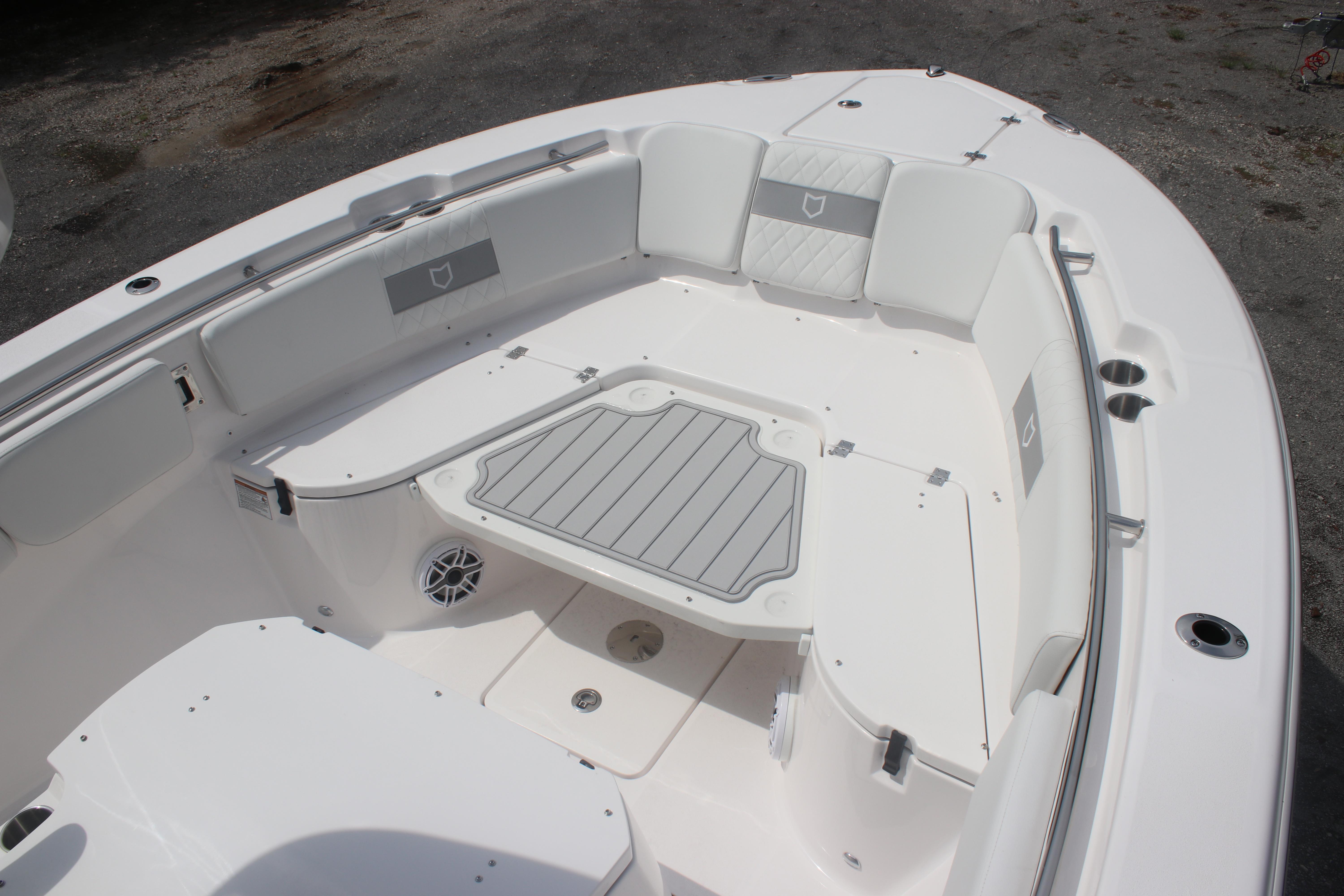 2026 Sea Fox 288 Commander boat interior with cushioned seating and storage compartments.