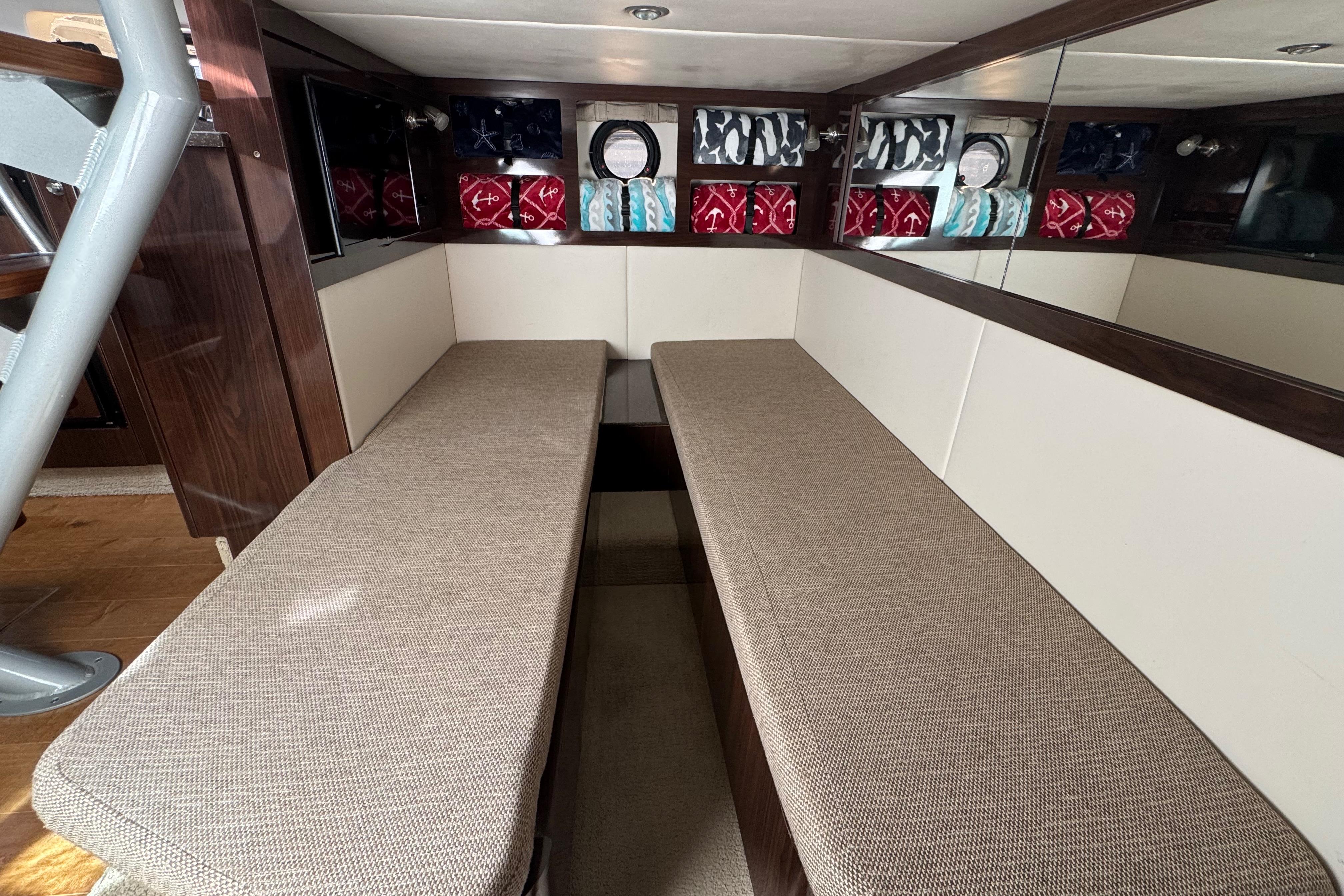 Interior cabin of 2016 Sea Ray Sundancer 350 with twin cushioned benches.