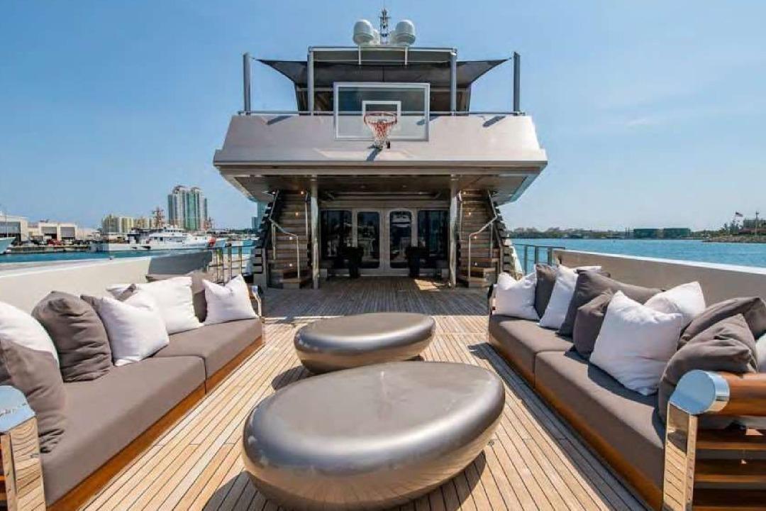 Luxurious 2004 Oceanfast 53 yacht deck with modern seating and basketball hoop.