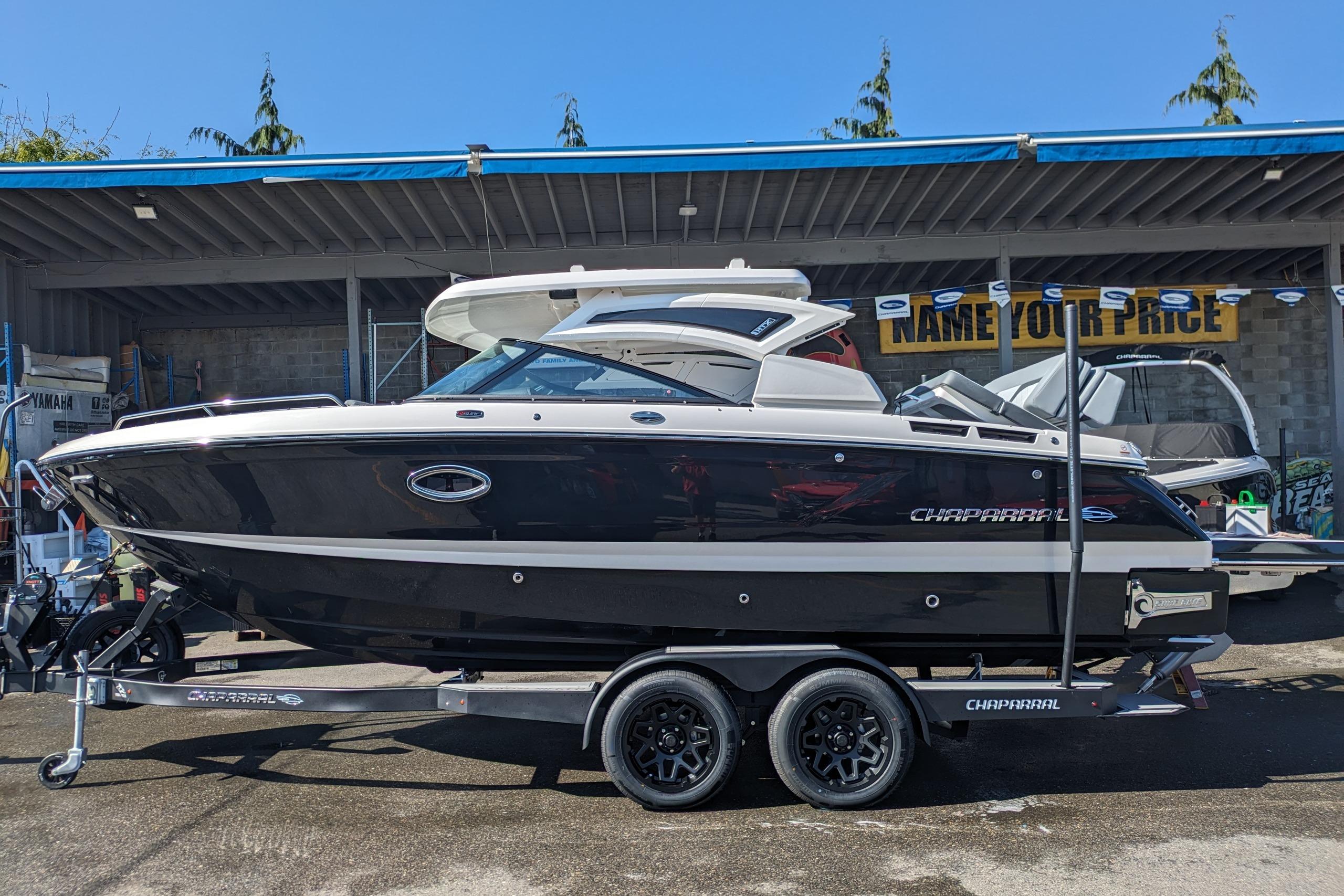 2026 Chaparral 6 GTS boat on trailer, displayed outdoors under a canopy.