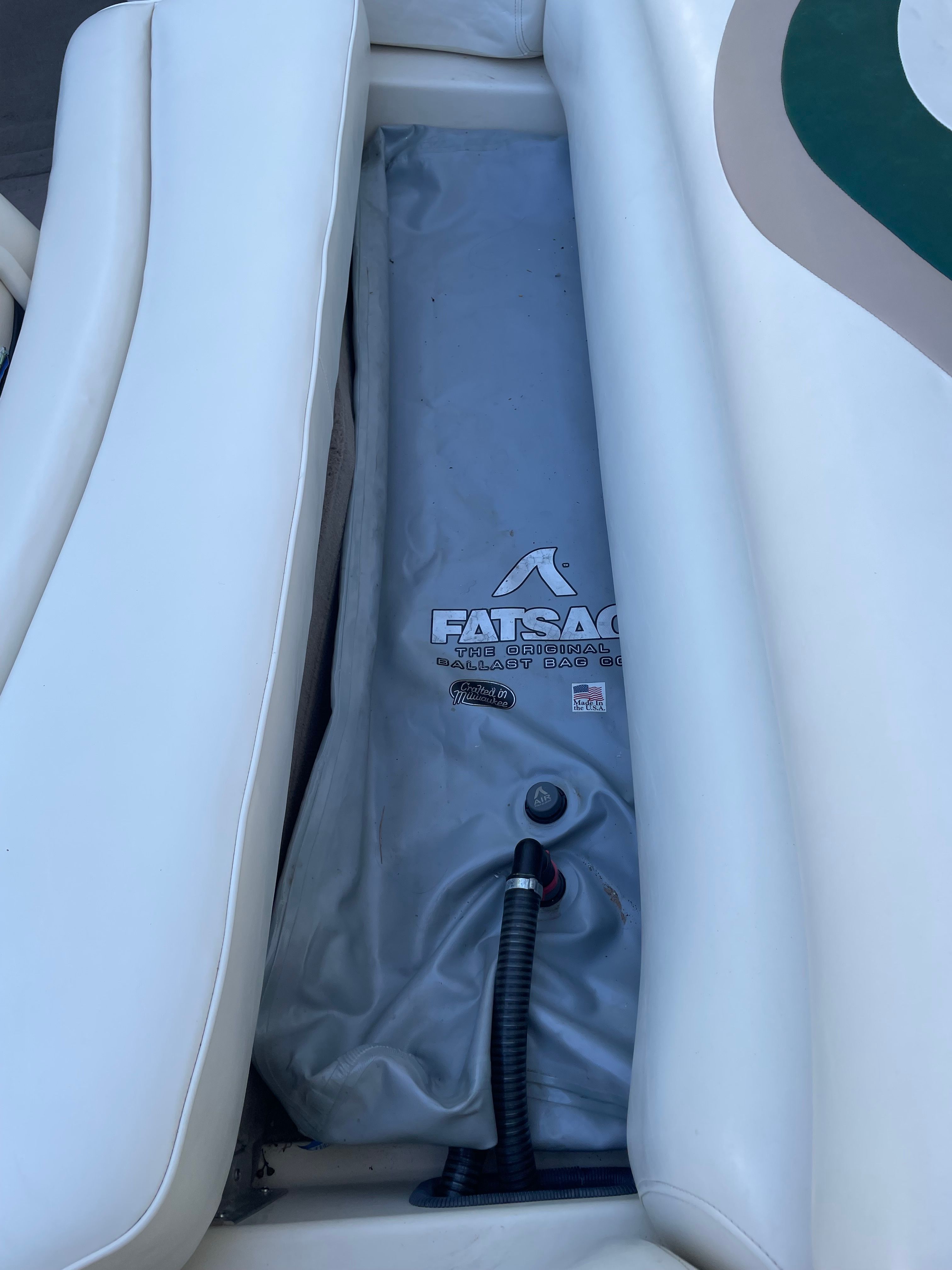 Close-up of a white boat seat with a gray Fatsac underneath.
