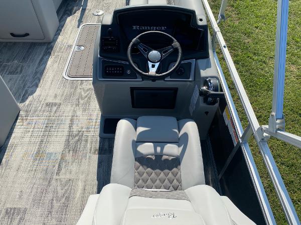 2024 Ranger Reata 223C boat interior with steering wheel and seating.