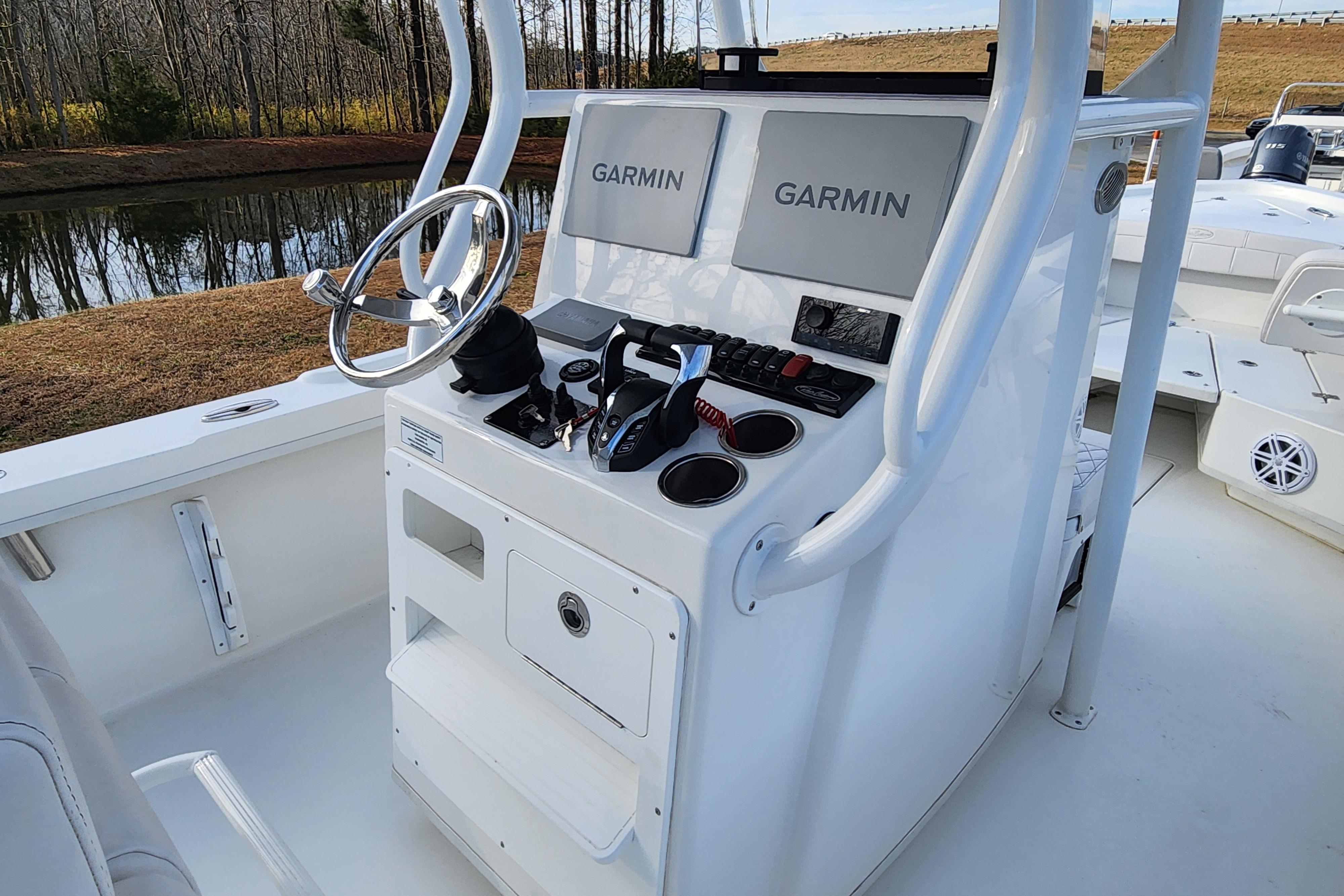 2024 Pair Customs 27 CC boat console with Garmin navigation systems and steering wheel.