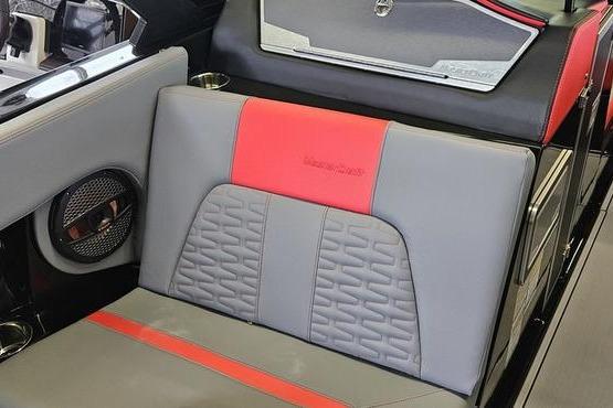 2025 MasterCraft X22 boat interior with gray and red seating, featuring modern design elements.