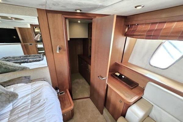 Luxurious interior of 2005 Sunseeker Manhattan 66 yacht cabin with wood finishes.