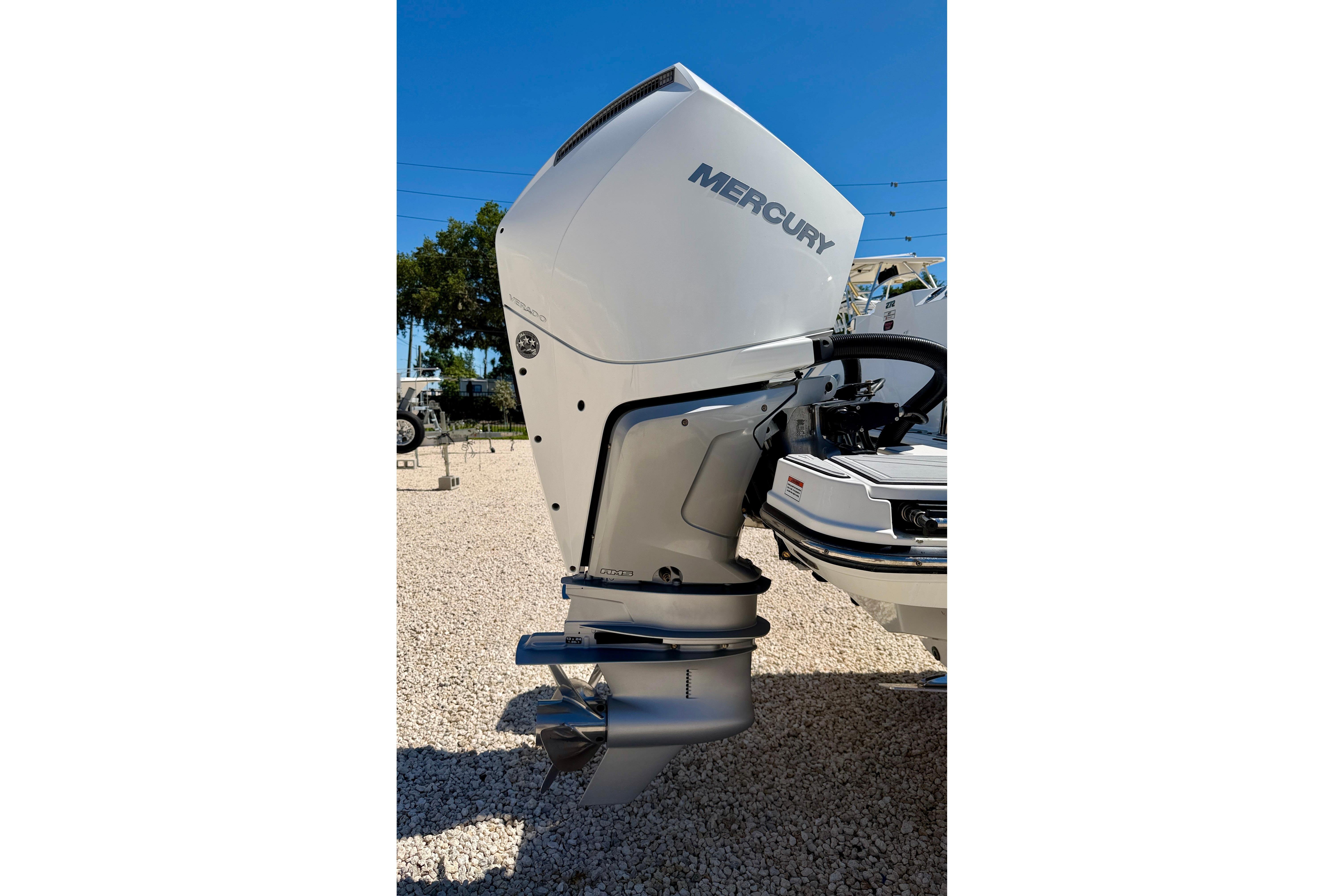 2023 Blackfin 272 DC boat with Mercury outboard motor in a sunny outdoor setting.