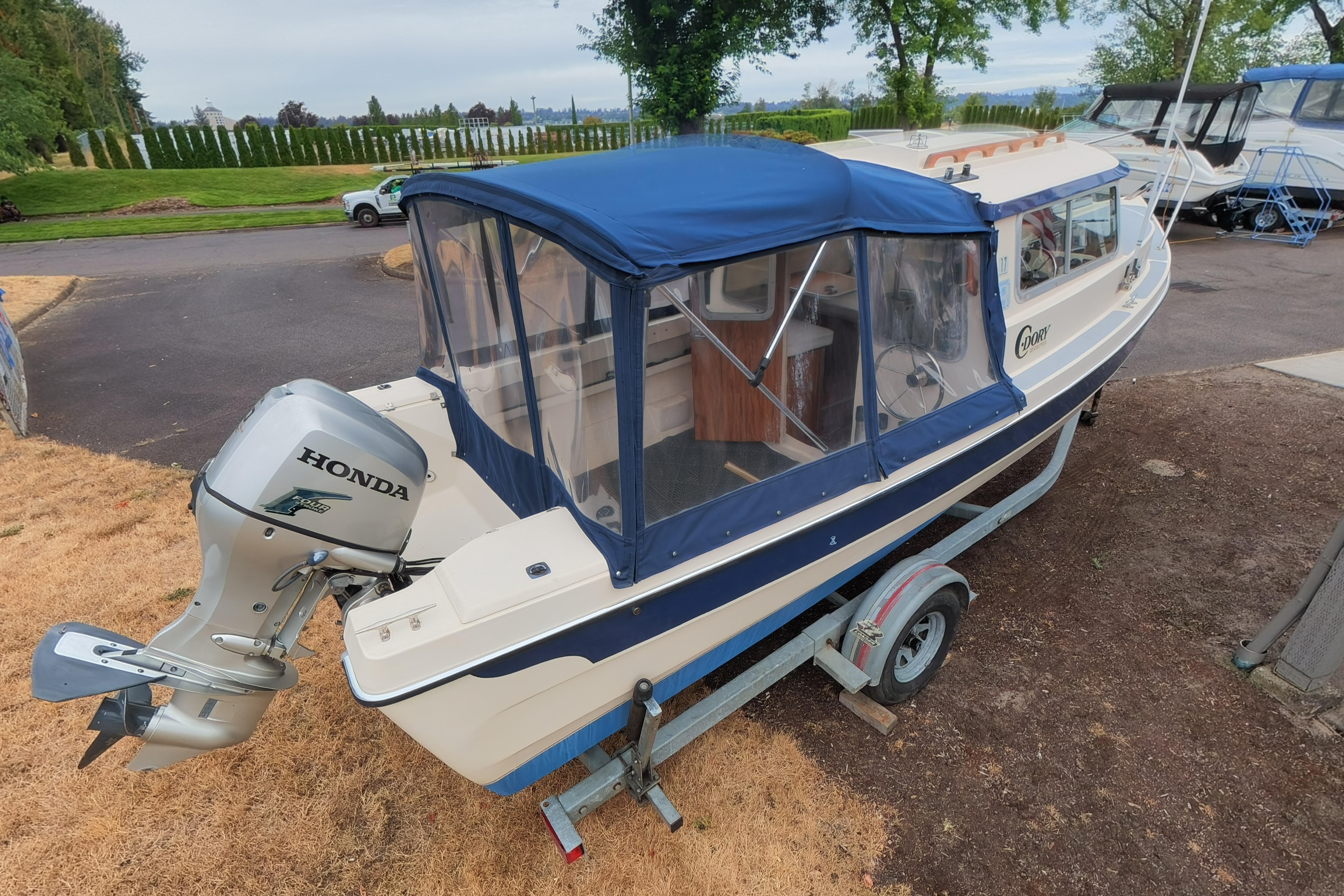 1989 C-Dory 22' Angler boat with Honda outboard motor on trailer.