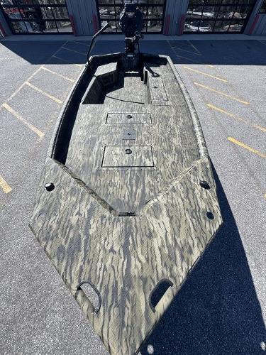 2025 SeaArk 1752 Slayer Pro boat with camouflage design, parked outdoors.