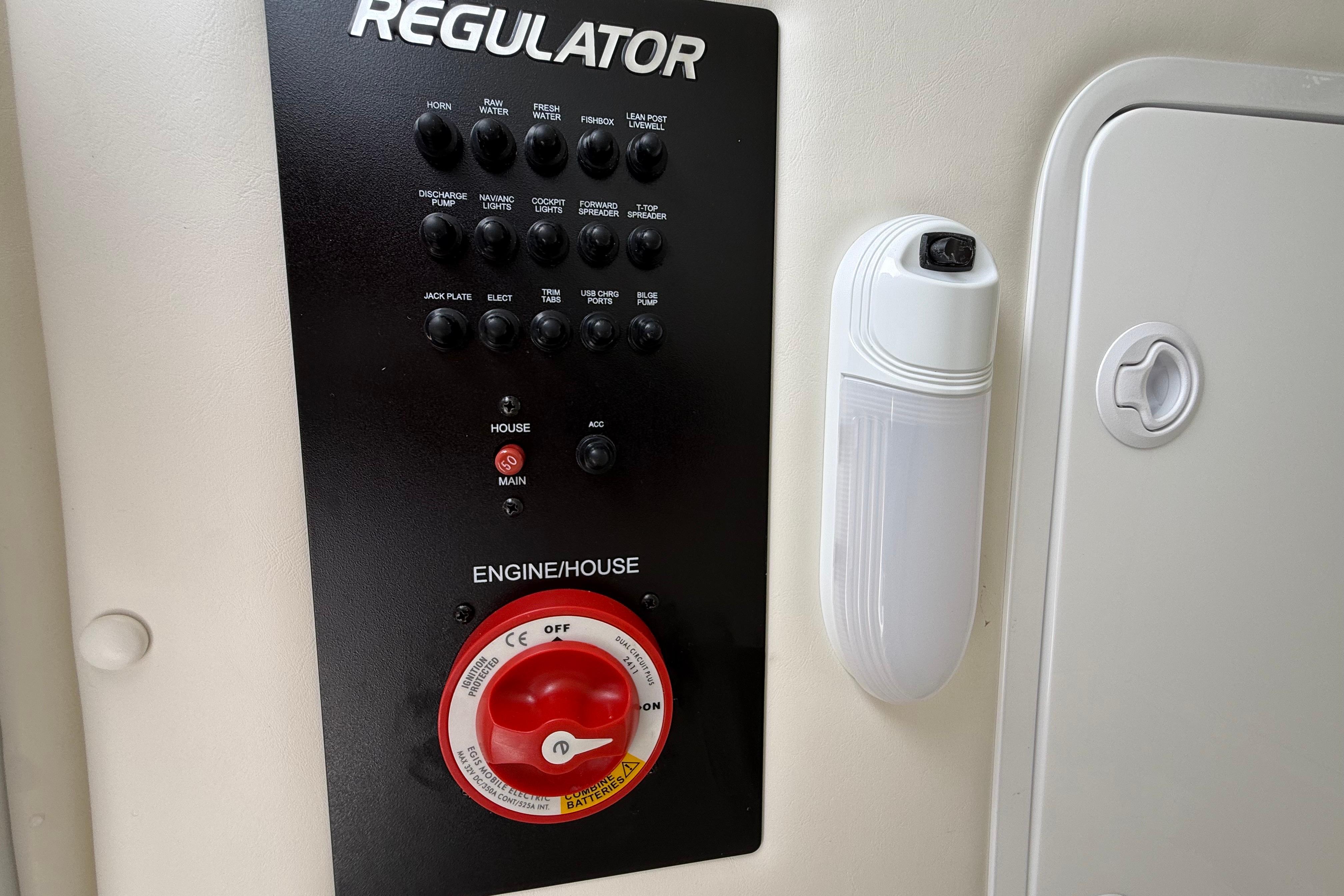 Control panel of a 2019 Regulator 26XO boat with switches and engine controls.