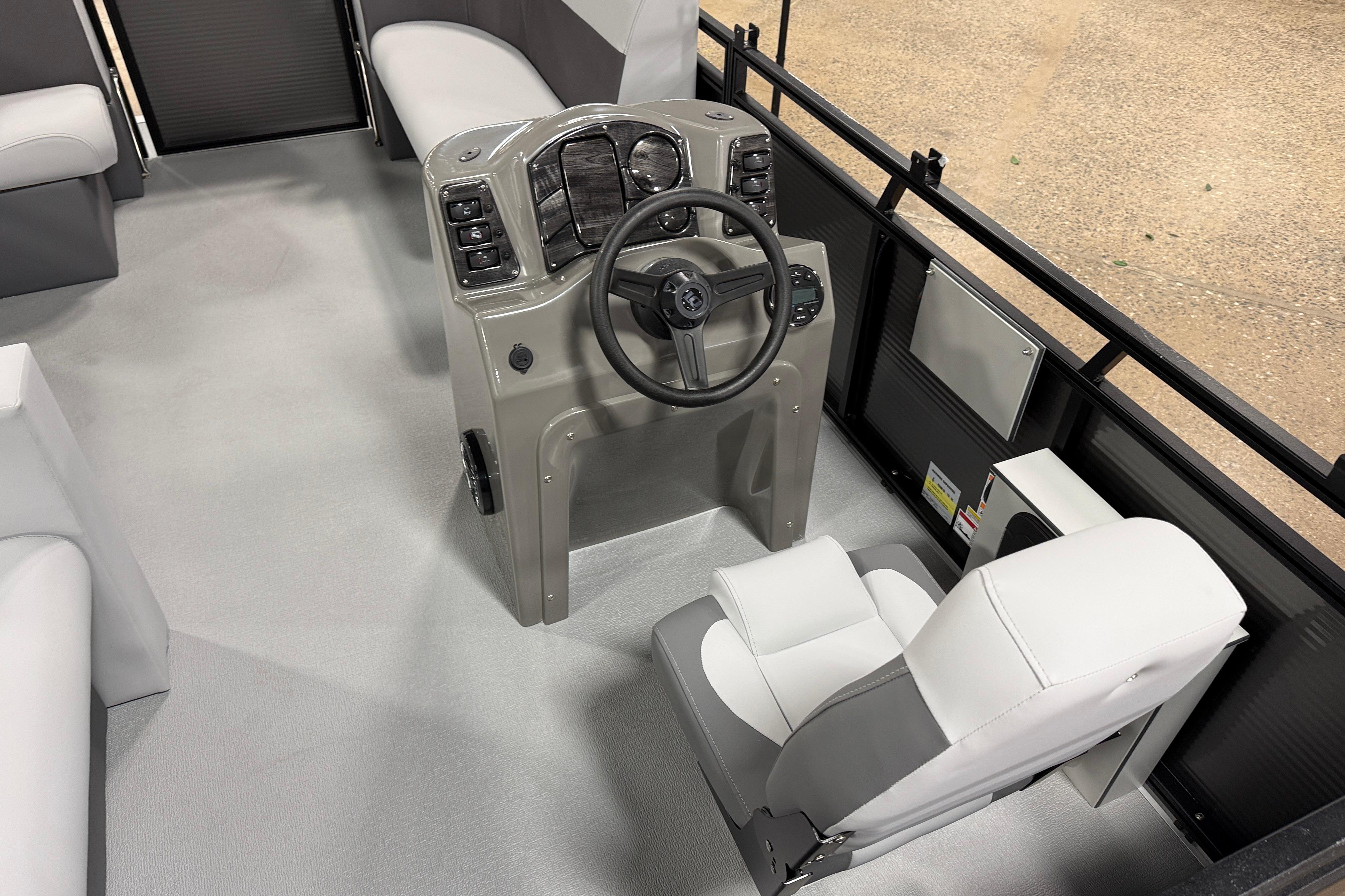 2026 Angler Quest 7515 Leisure Quest Cruise boat interior with steering console and seating.