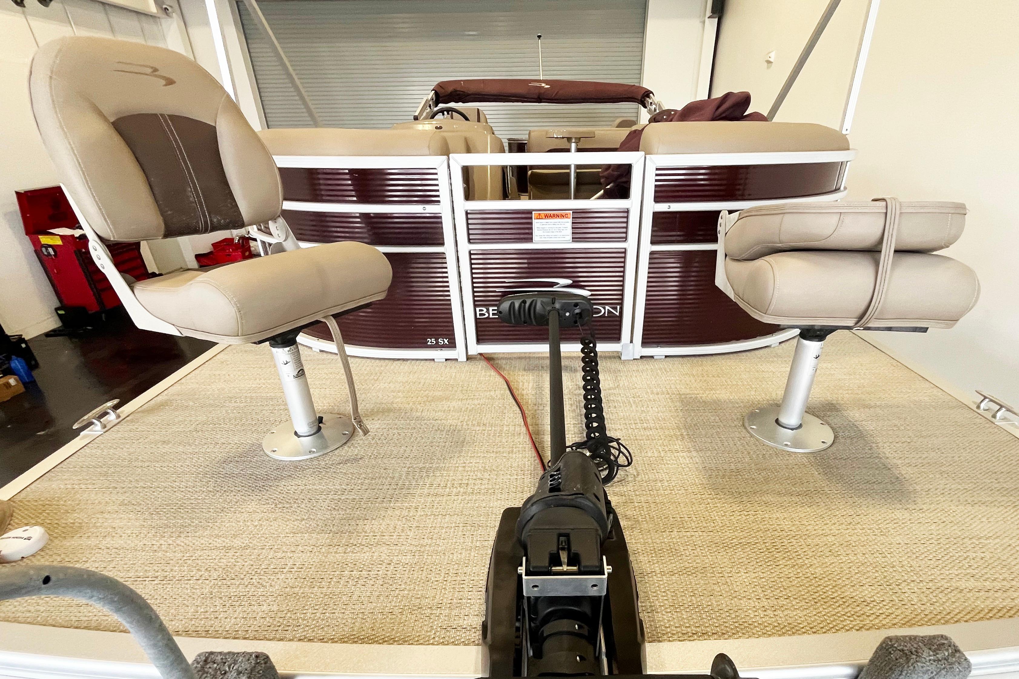 2020 Bennington SX25 pontoon boat interior with beige seats and carpeted deck.