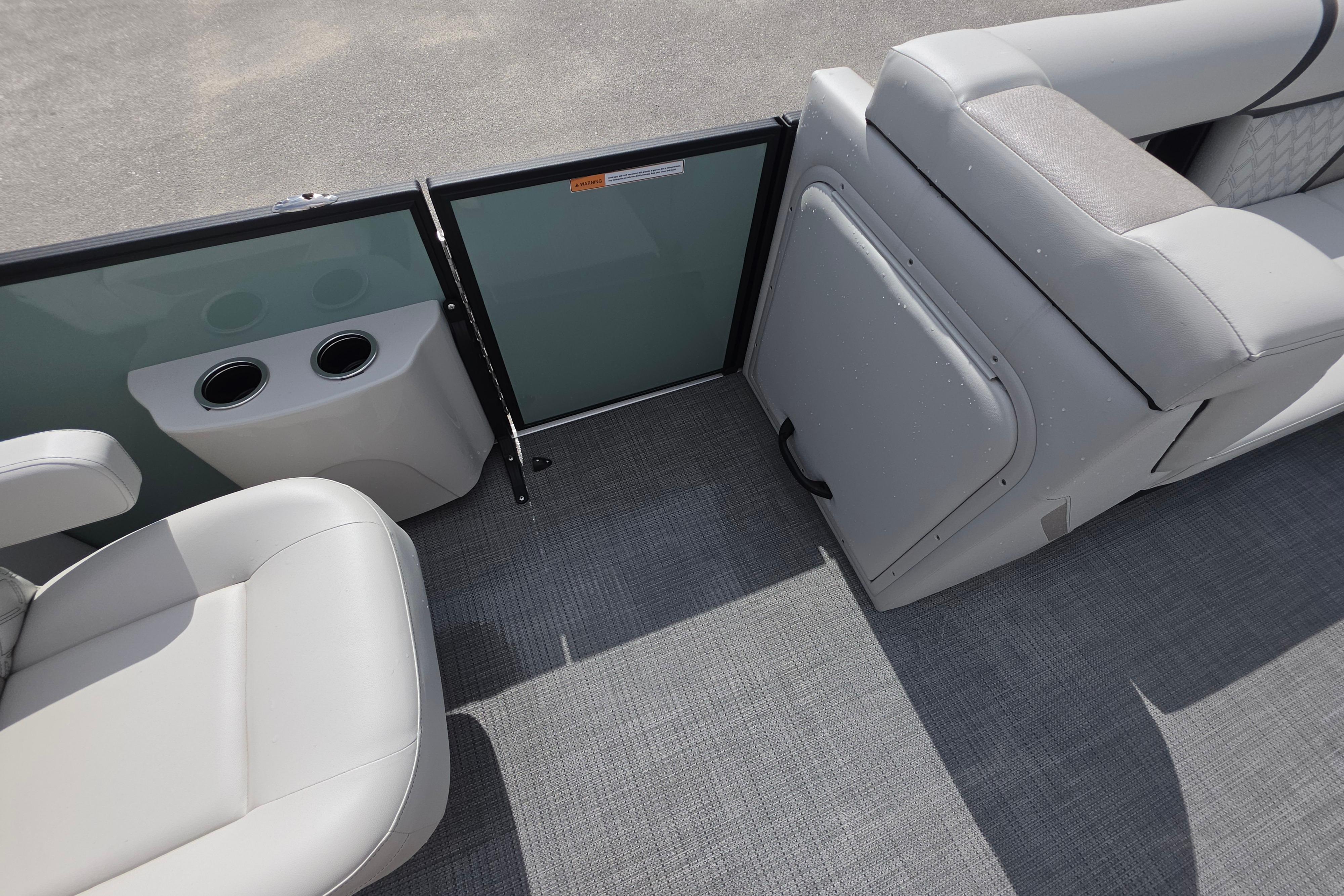 Interior of 2026 Crest 235 Conquest SLC boat with seating and cup holders.