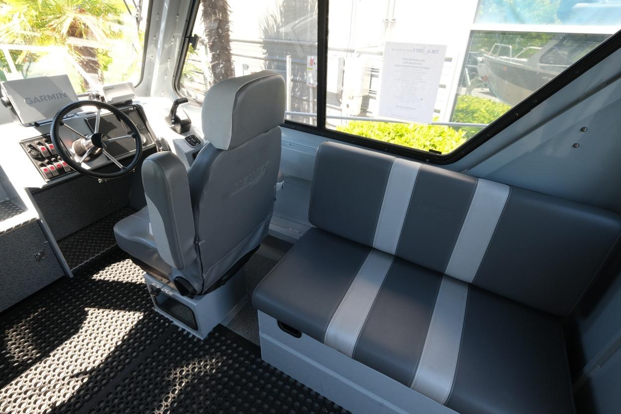 Interior of 2018 Hewescraft 220 Ocean Pro ET Hardtop with seating and steering wheel.